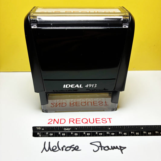 Rubber stamp with '2ND REQUEST' text on a white surface with a yellow background