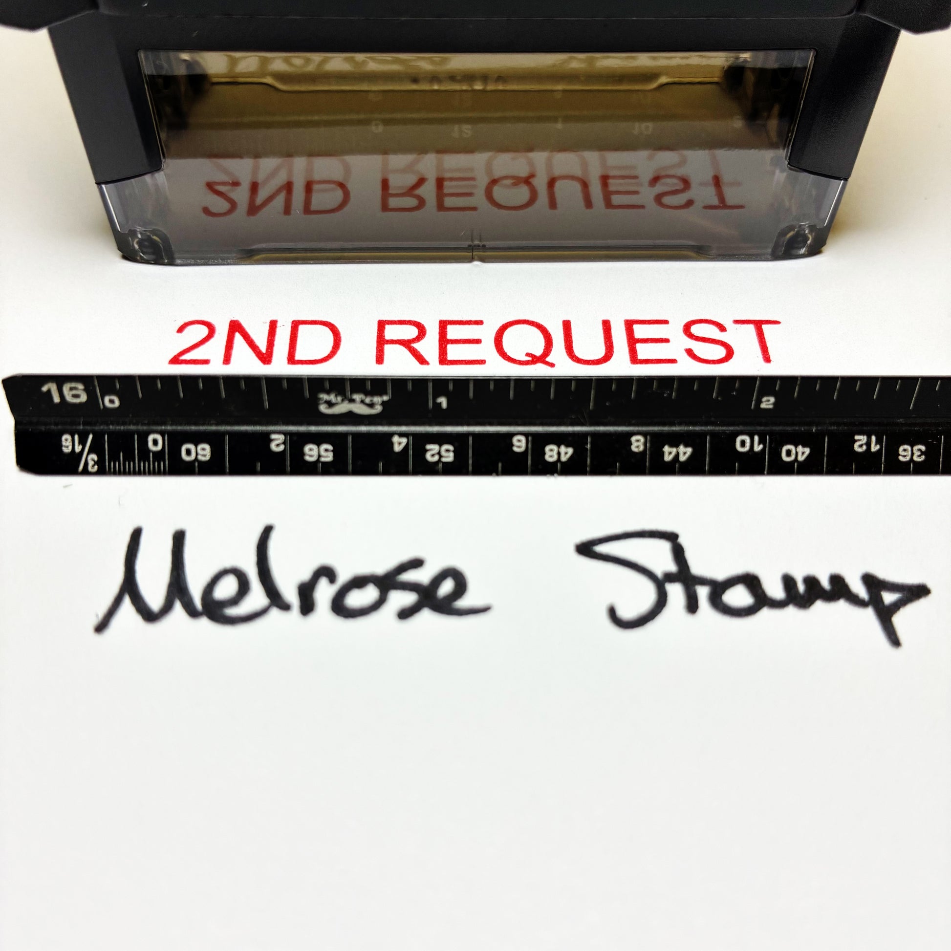 Rubber stamp with '2nd Request' text and a ruler for scale on a white background.