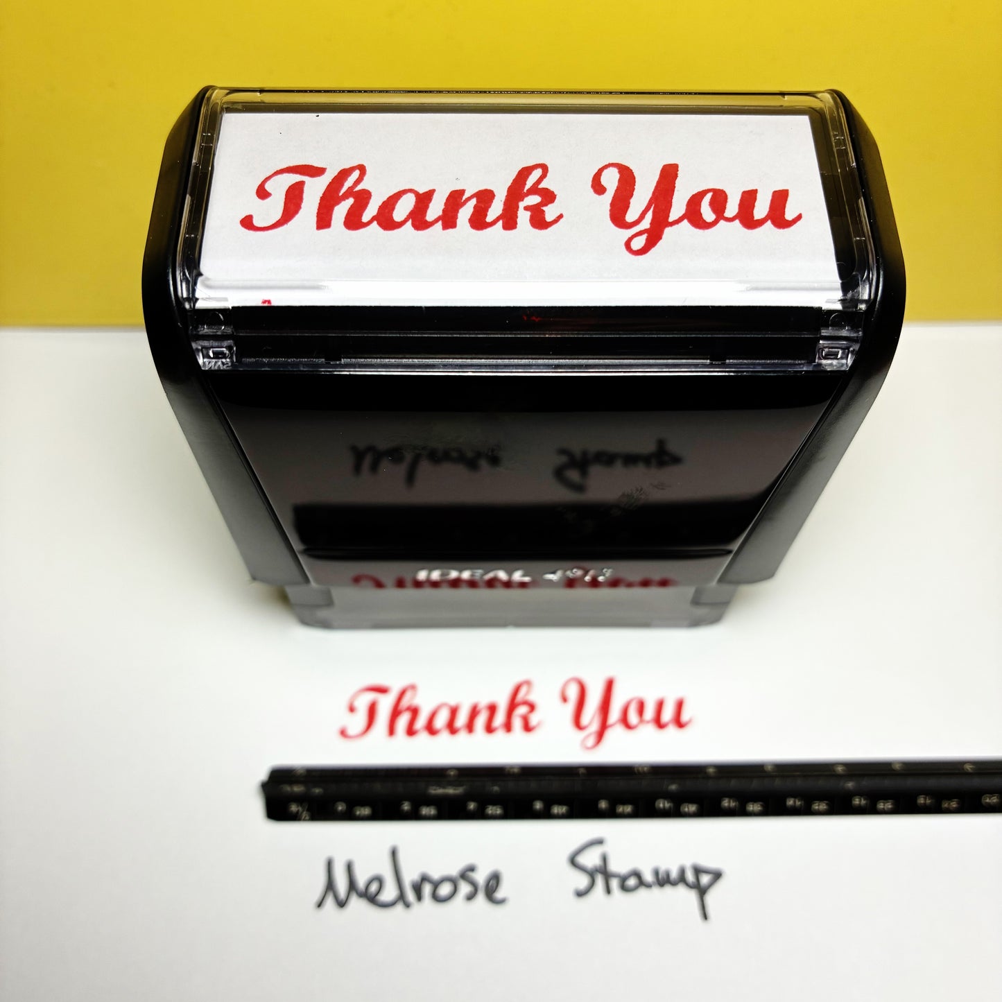 Self-inking stamp with 'Thank You' text on a white background