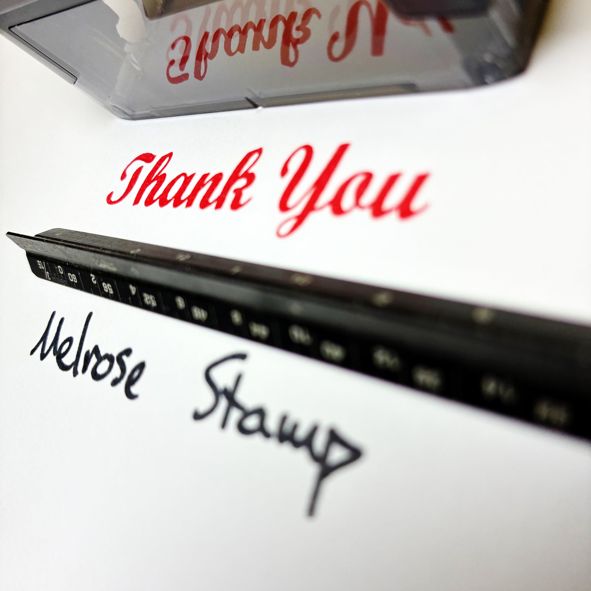 Close-up of a rubber stamp with 'Thank You' text and 'Melrose Stamp' branding.