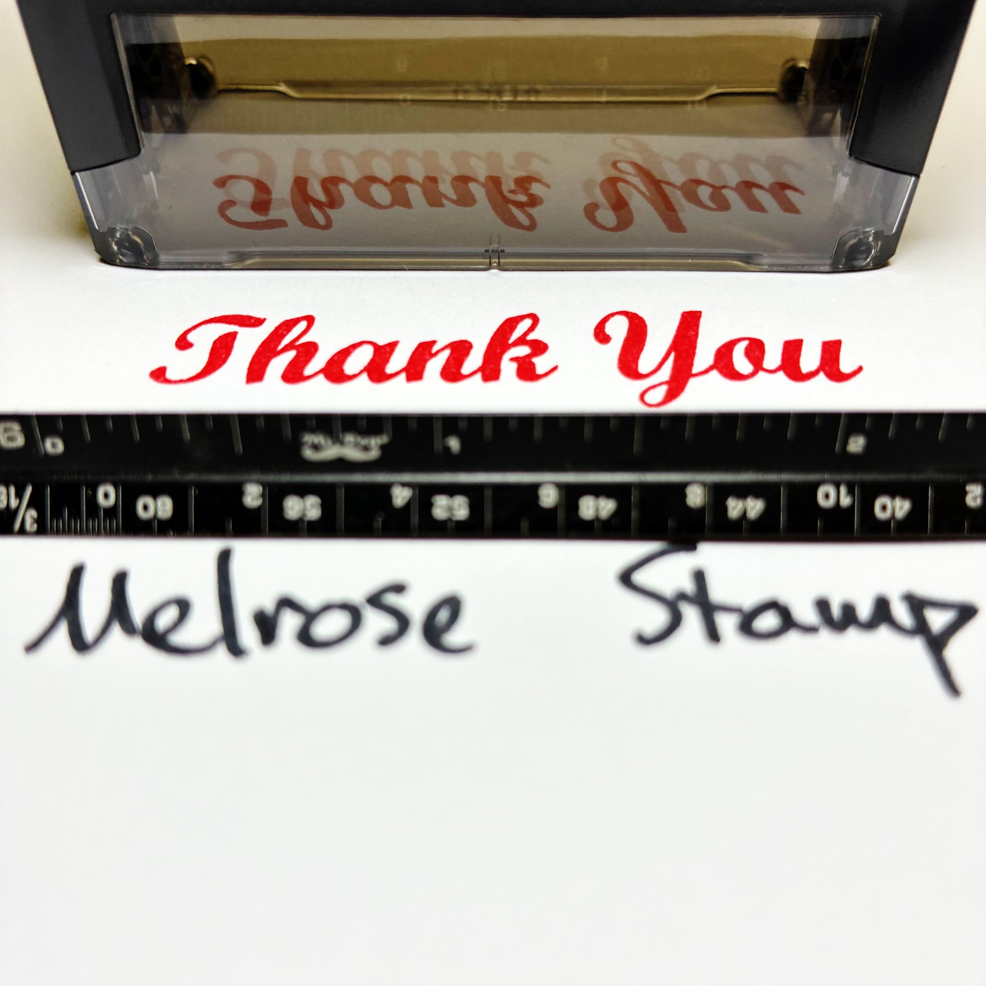 Rubber Stamp with 'Thank You' text red ink self-inking and a ruler showing measurement details.