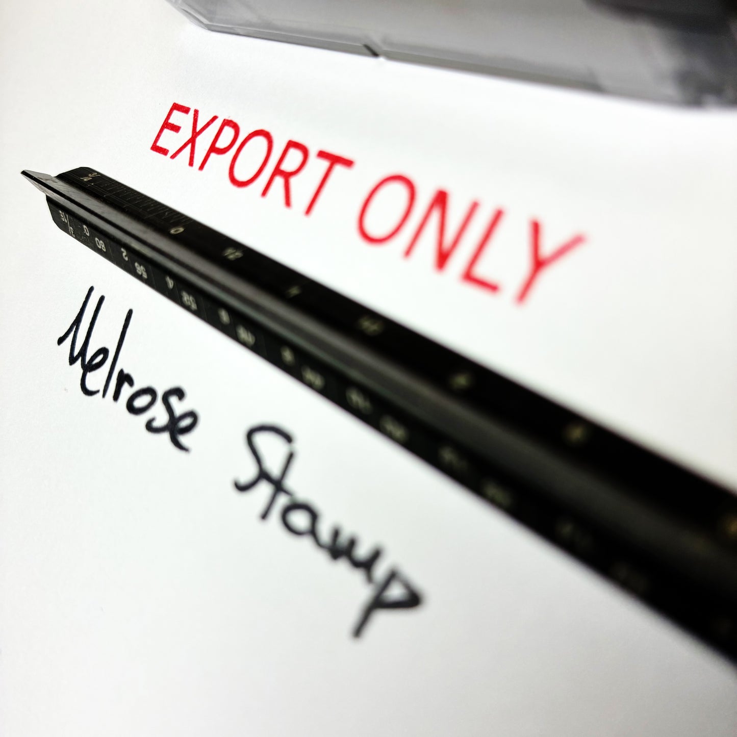 Black stamp with 'Export Only' and 'Melrose Stamp' text on a white background