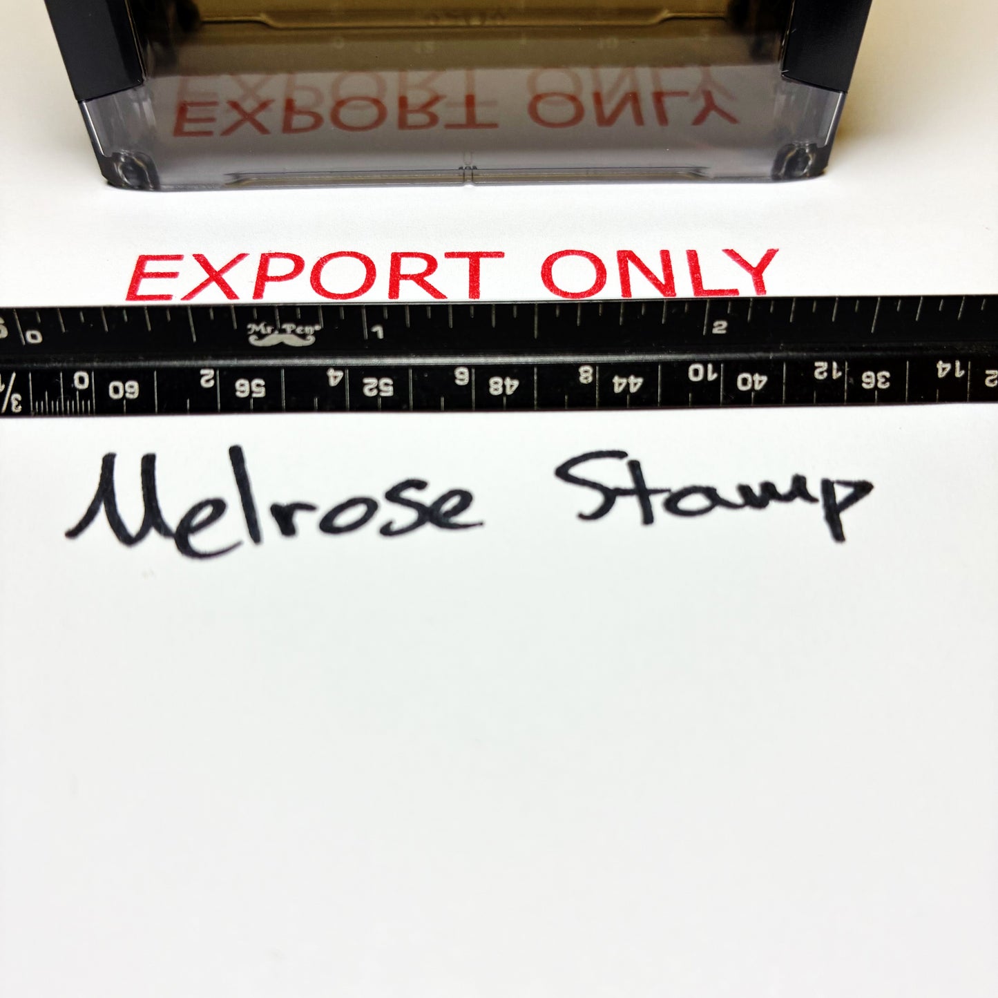 Stamp with 'EXPORT ONLY' text and a ruler below on a white background