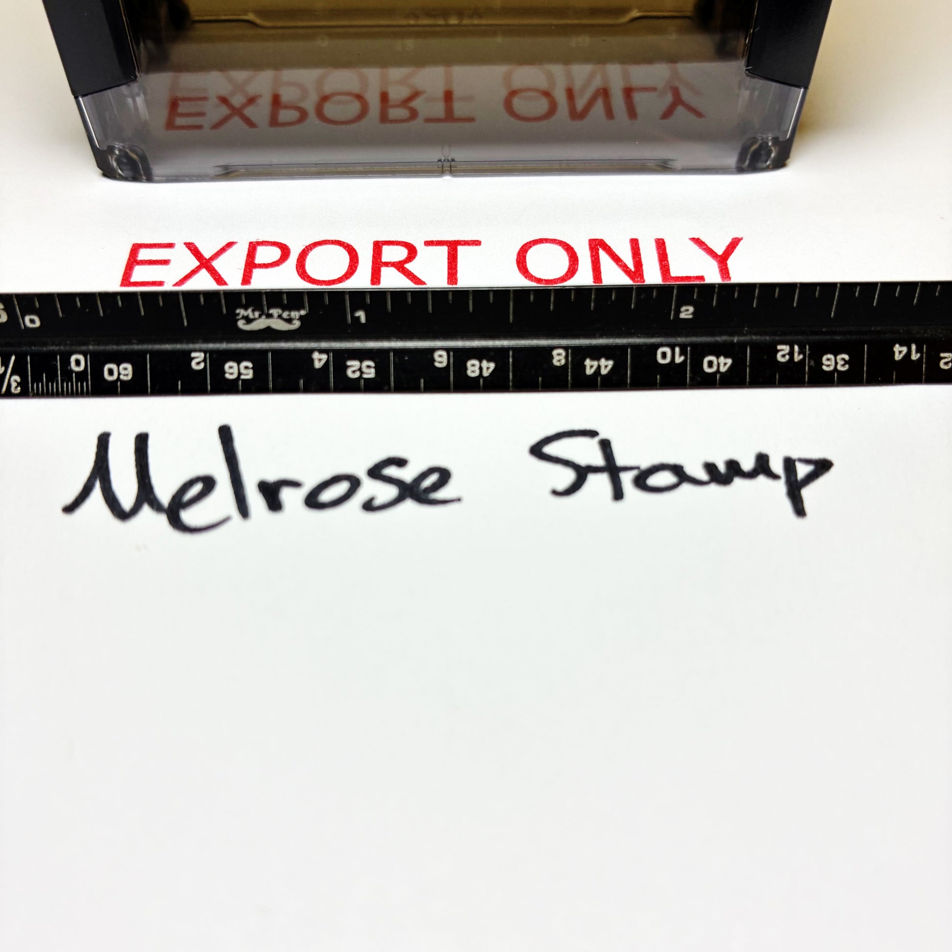 Stamp with 'EXPORT ONLY' text and a ruler below on a white background