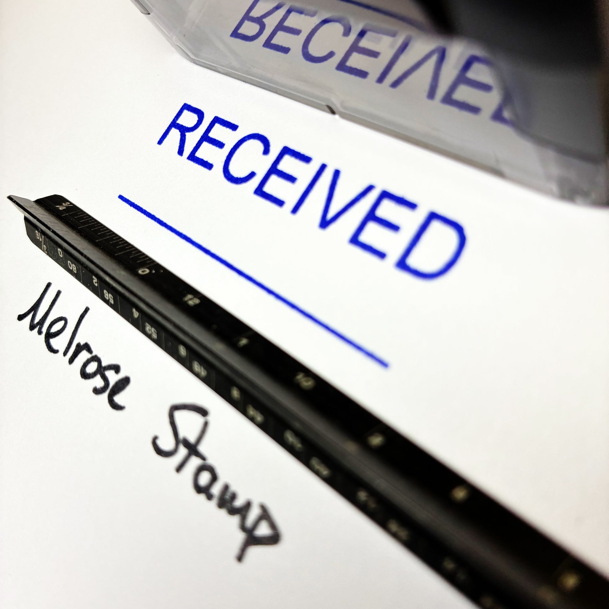 Close-up of a stamp with 'RECEIVED' text and 'Melrose Stamp' branding.