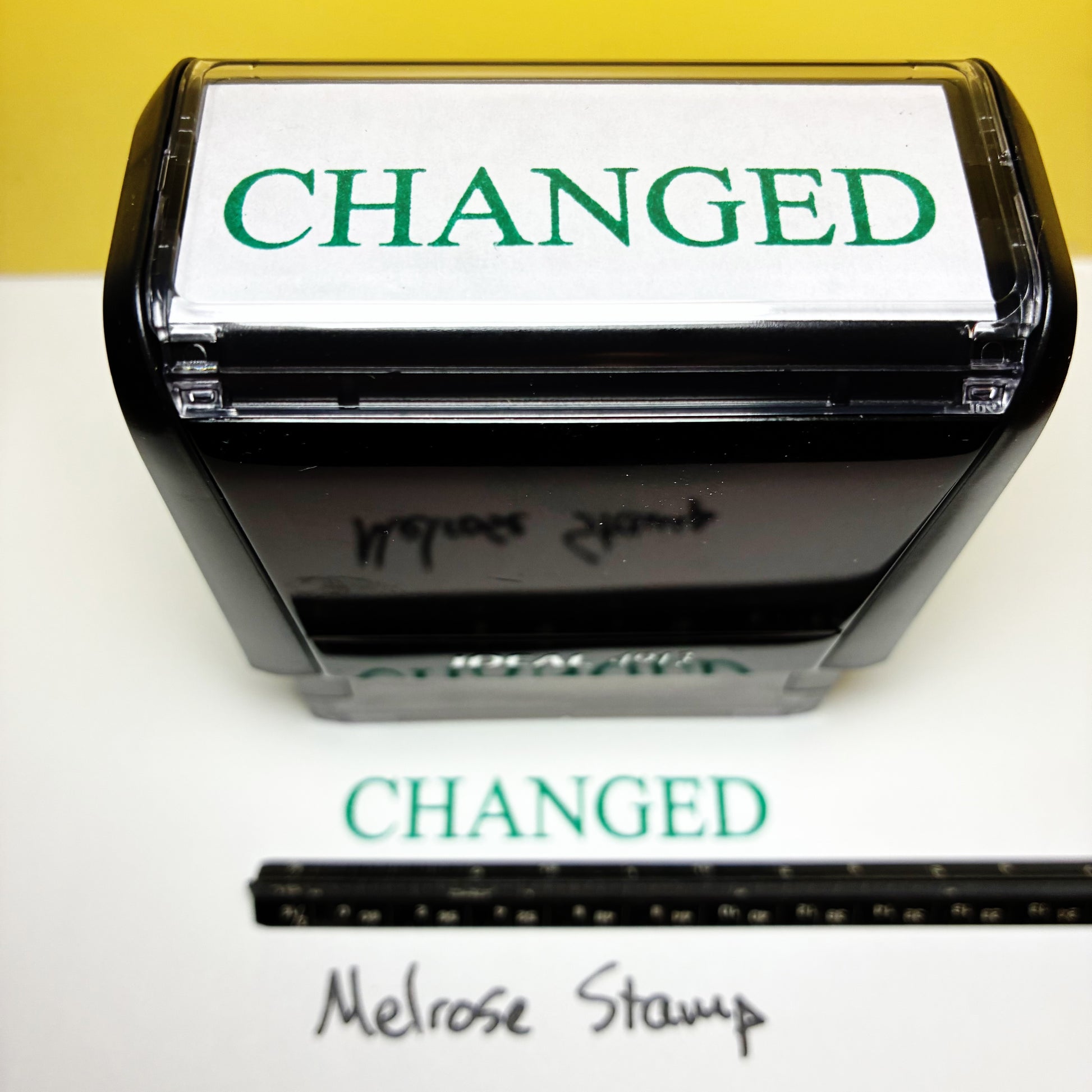 Self-inking stamp with 'CHANGED' text on a white background