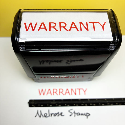 Rubber stamp with 'WARRANTY' text on a white background