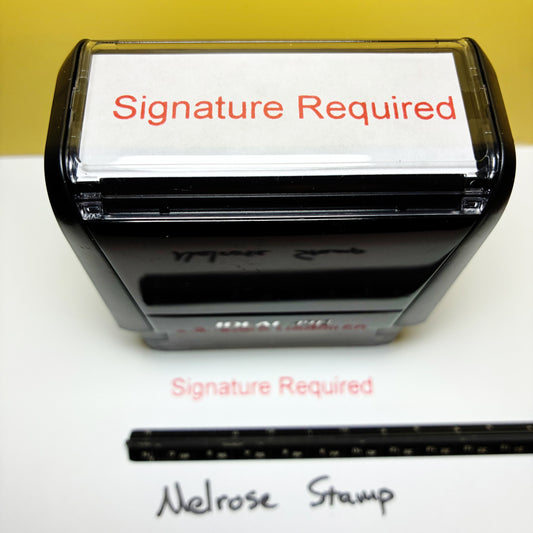 Rubber stamp with 'Signature Required' text red ink on a white background