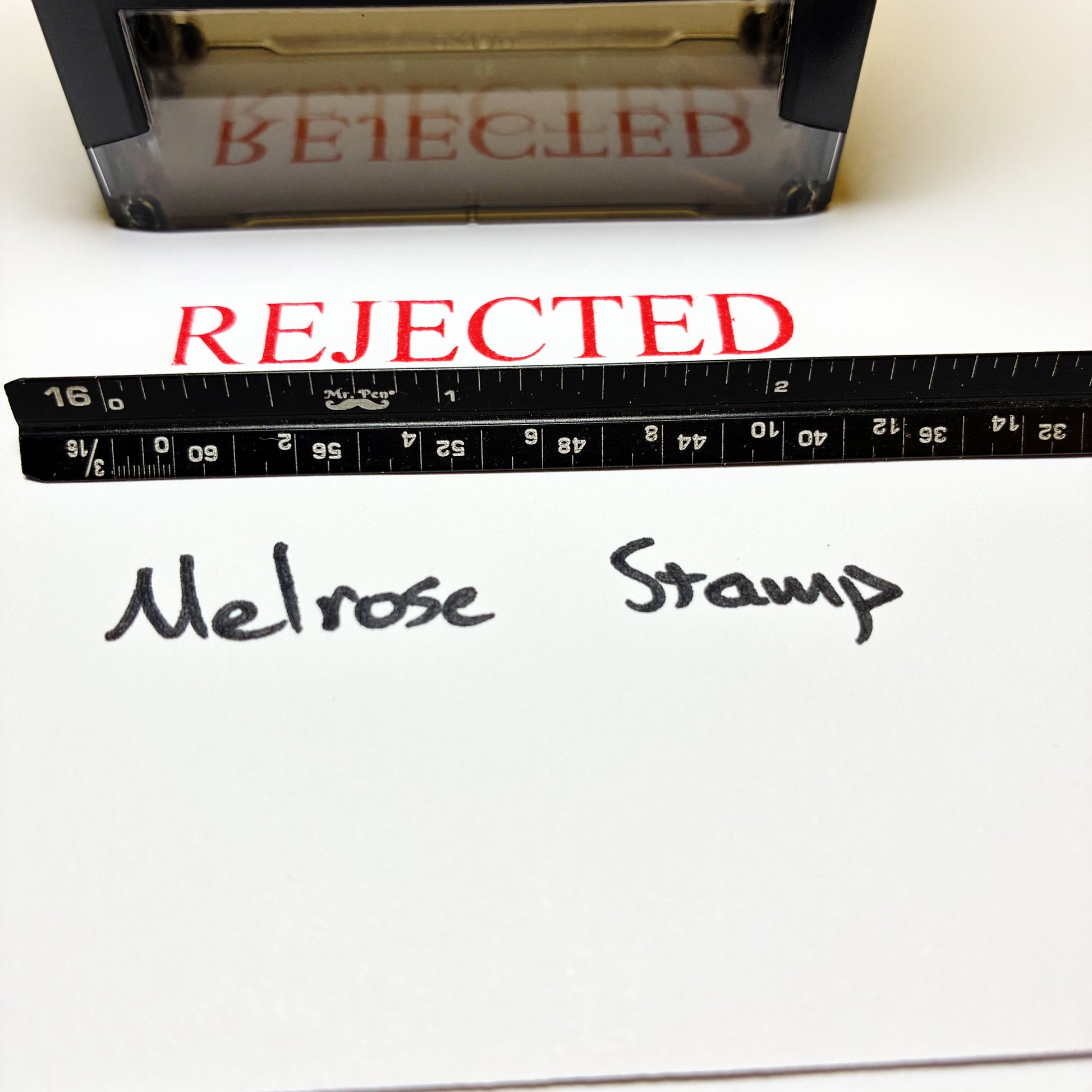 Stamp with 'REJECTED' text next to a ruler and 'Melrose Stamp' branding on a white background