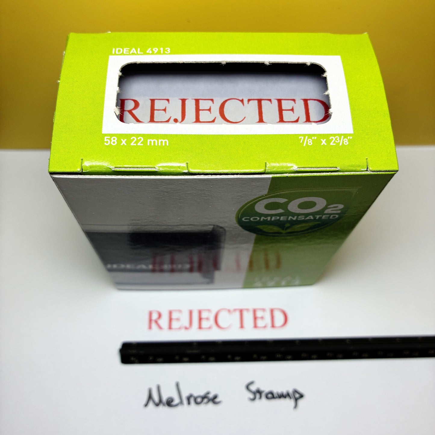 Rubber stamps with 'REJECTED' text on a white surface