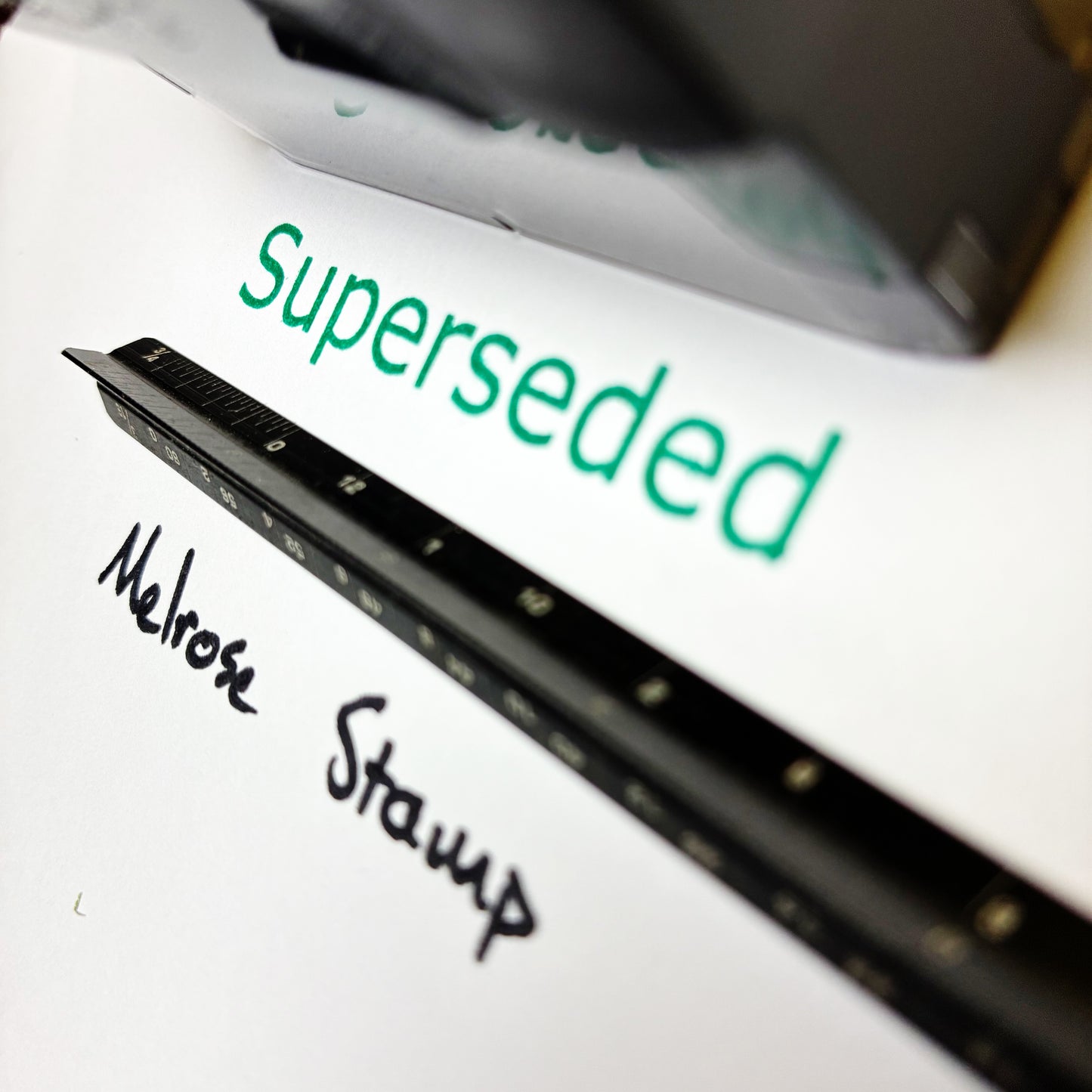 Document with 'Superseded' and 'Melrose Stamp' text on a white background rubber stamp green ink