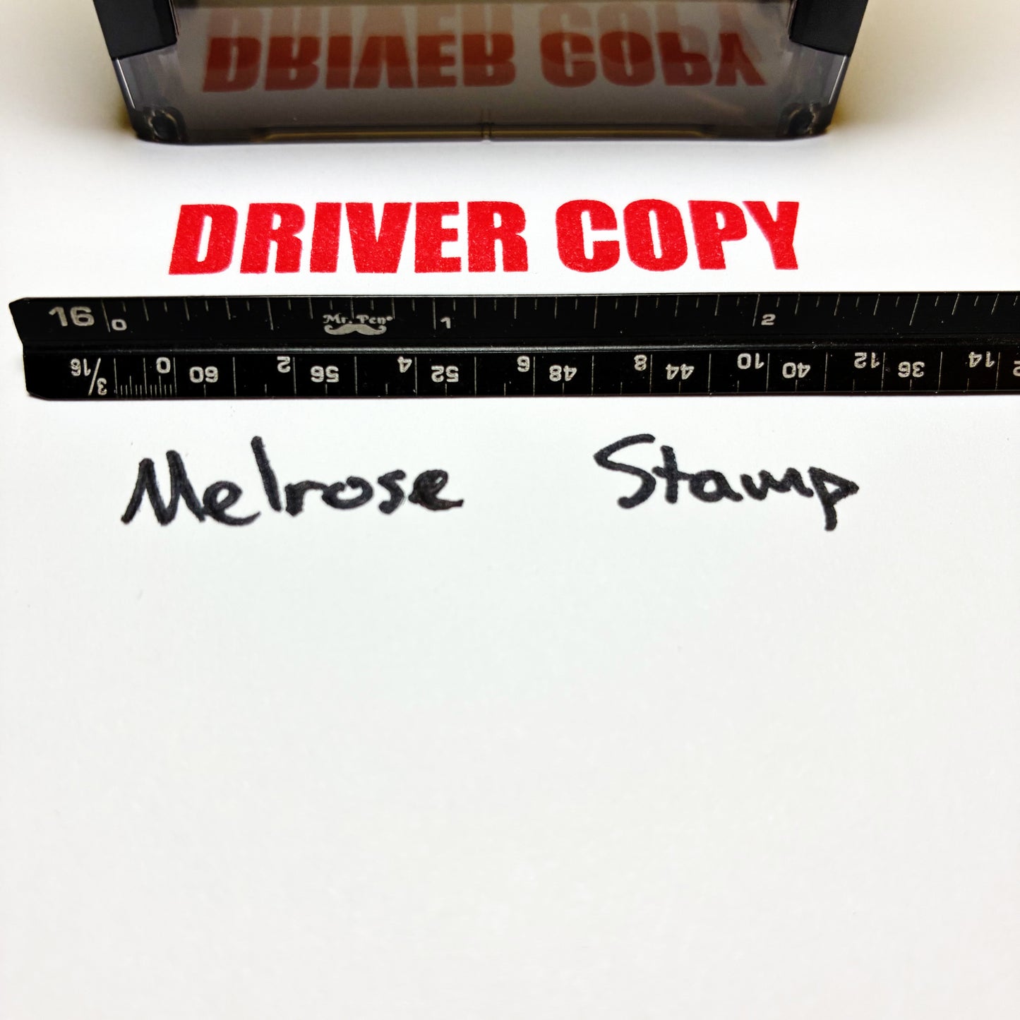 Rubber stamp with 'DRIVER COPY' text and a ruler on a white background red ink