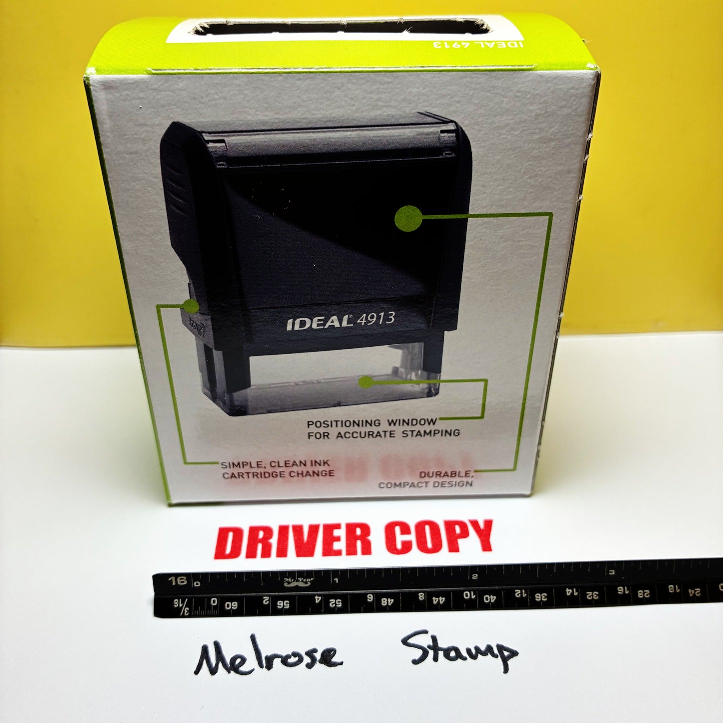 Boxed Ideal 4913 stamp with a ruler for scale on a white surface Driver Copy rubber stamp red ink