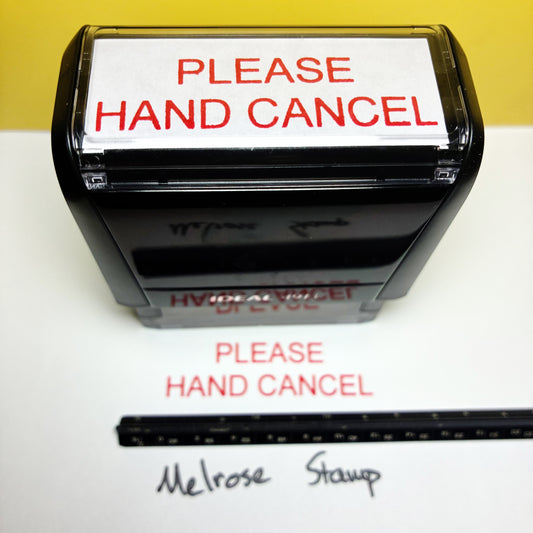 Rubber stamp with 'PLEASE HAND CANCEL' text on a white background