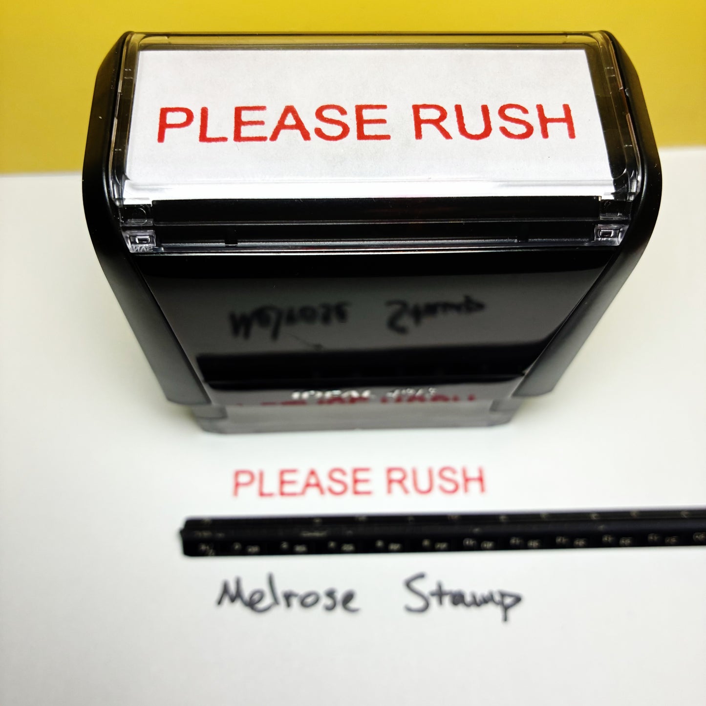 Rubber stamp with 'PLEASE RUSH' text on a white background