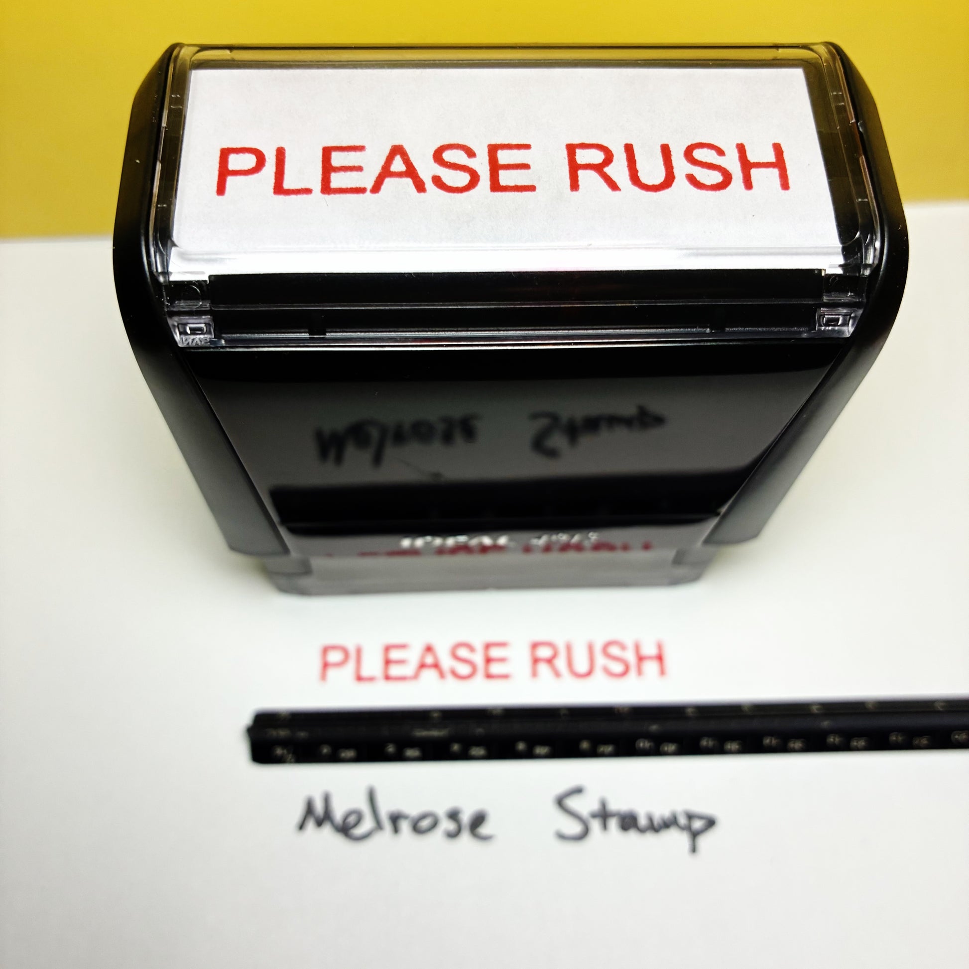 Rubber stamp with 'PLEASE RUSH' text on a white background