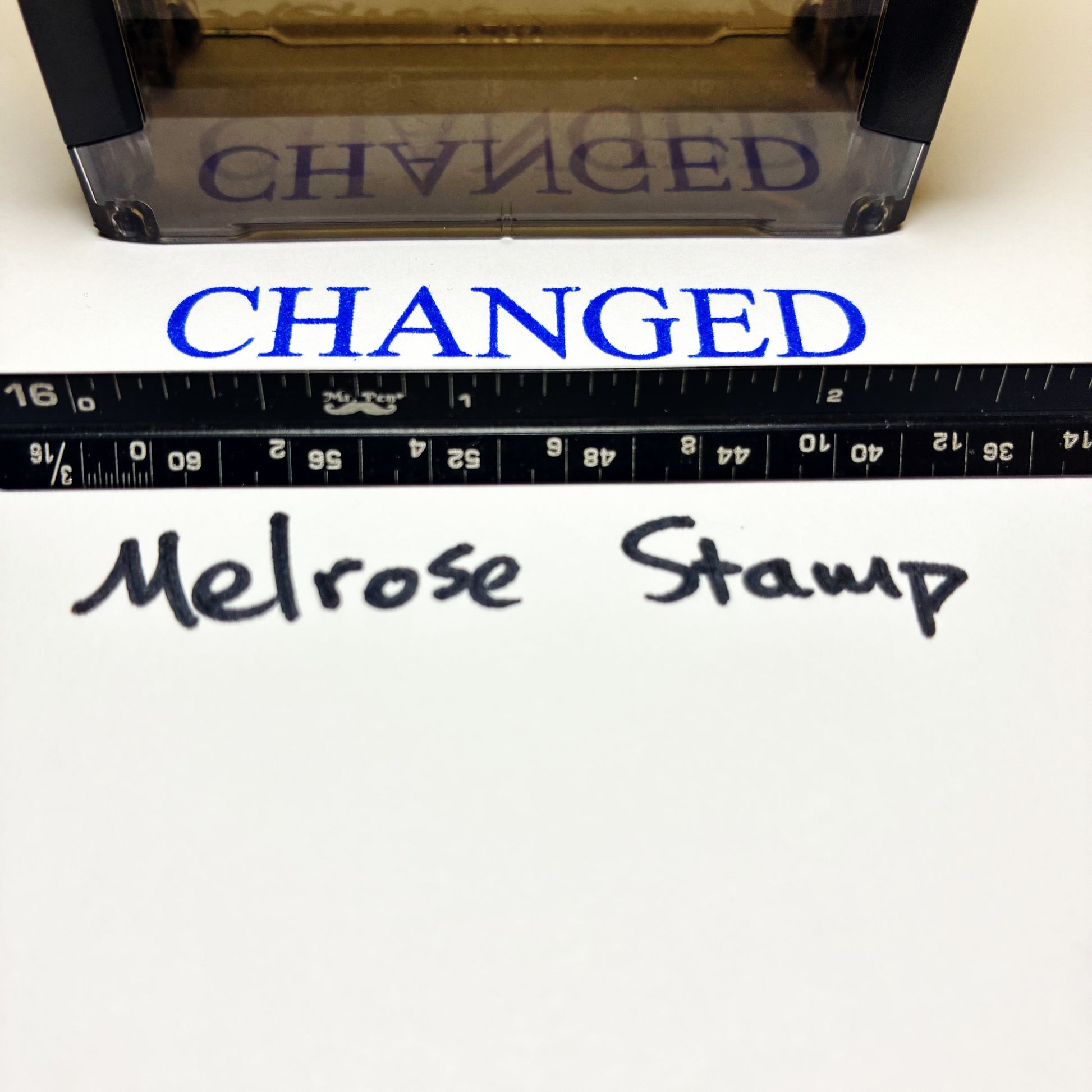 Stamp with 'CHANGED' text next to a ruler and 'Melrose Stamp' branding.
