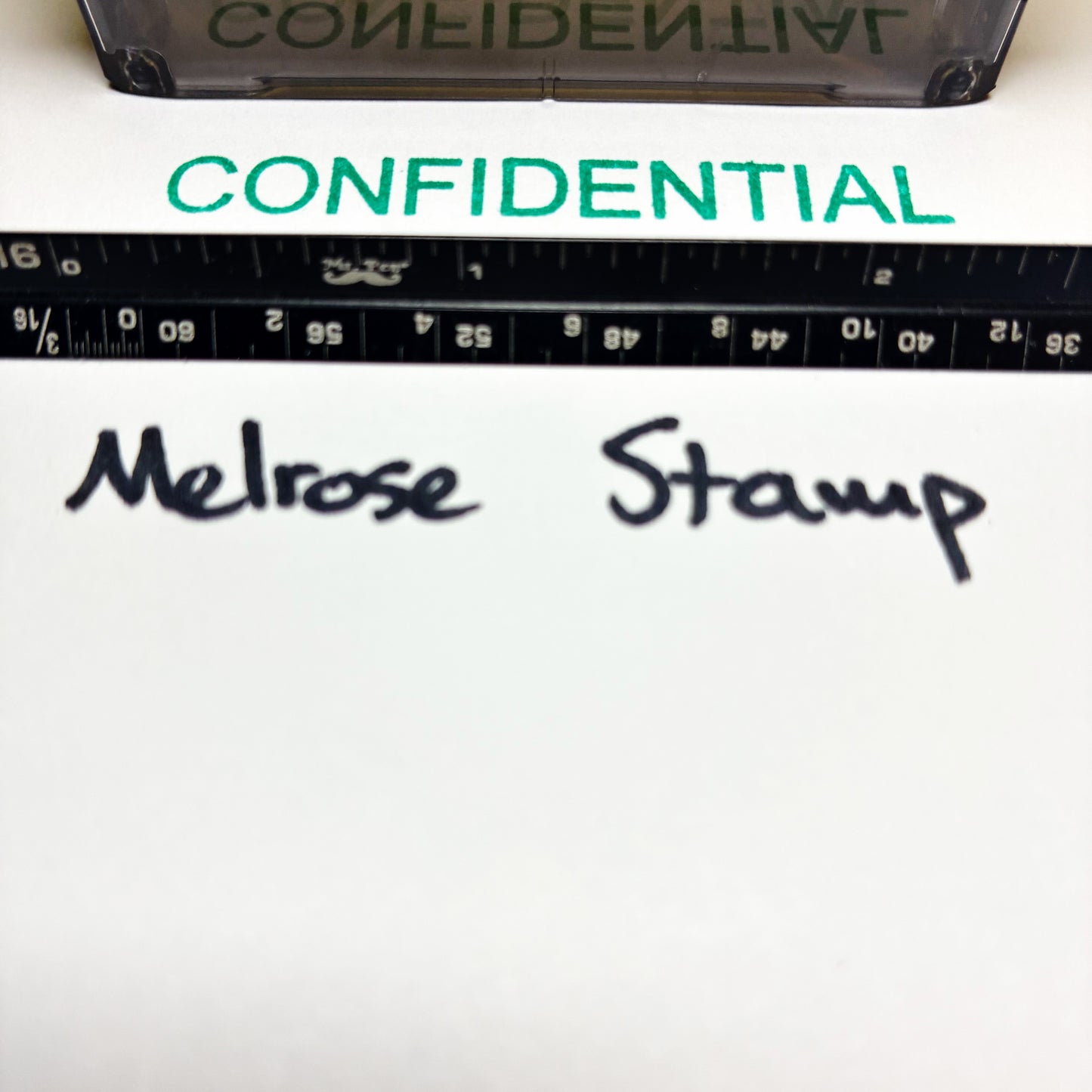 Confidential stamp green ink on a document with 'Melrose Stamp' branding.
