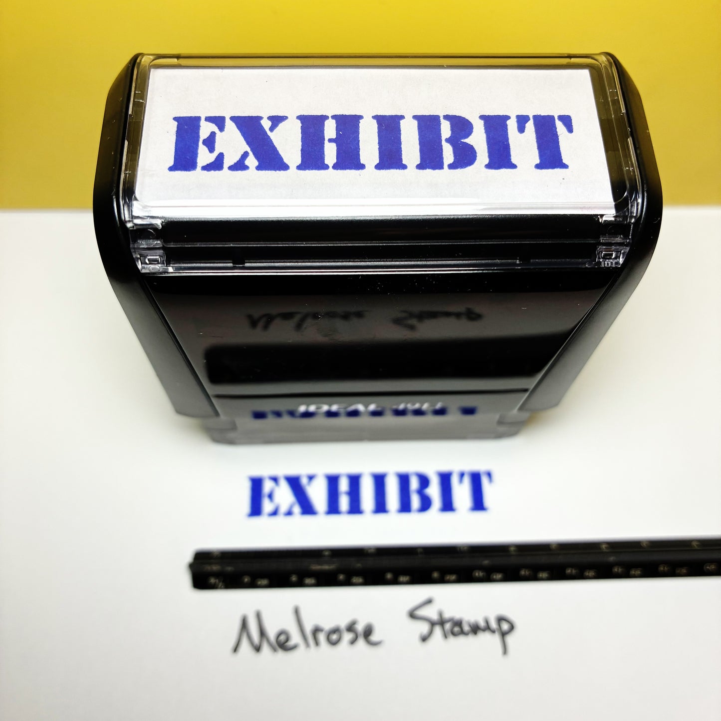 Rubber stamp with 'EXHIBIT' text on a white background, featuring the brand 'Melrose Stamp'.