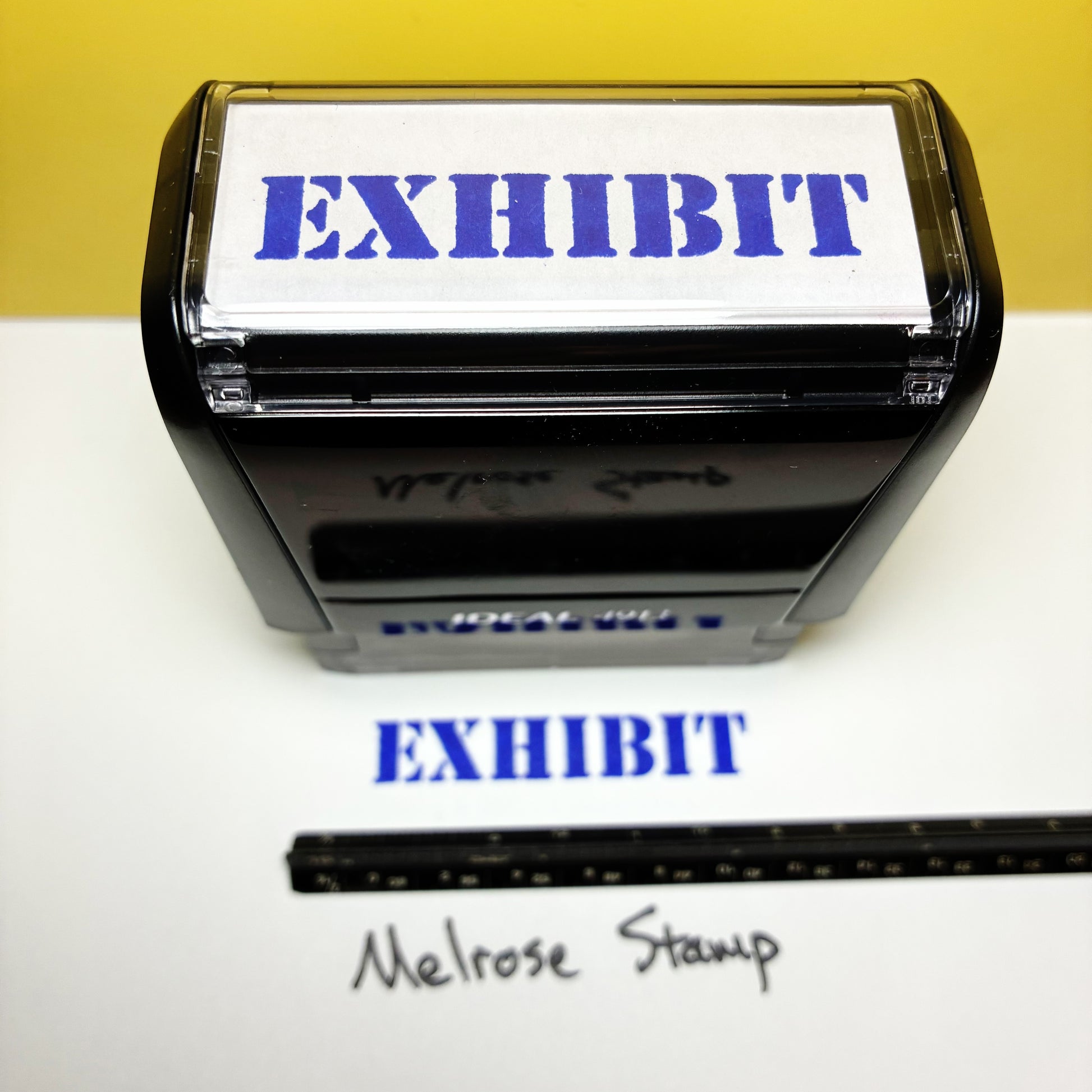 Rubber stamp with 'EXHIBIT' text on a white background, featuring the brand 'Melrose Stamp'.
