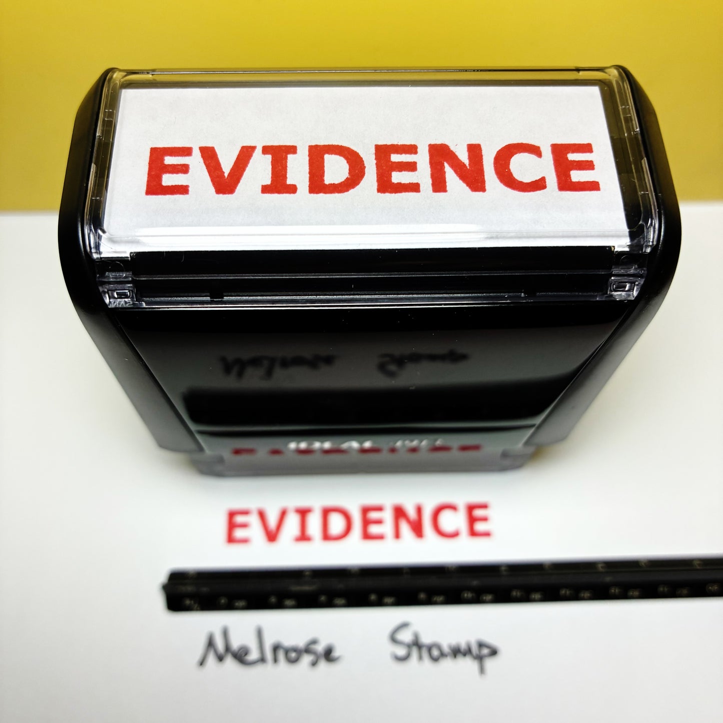 Rubber stamp with 'EVIDENCE' text on a white background, showing a sample impression.