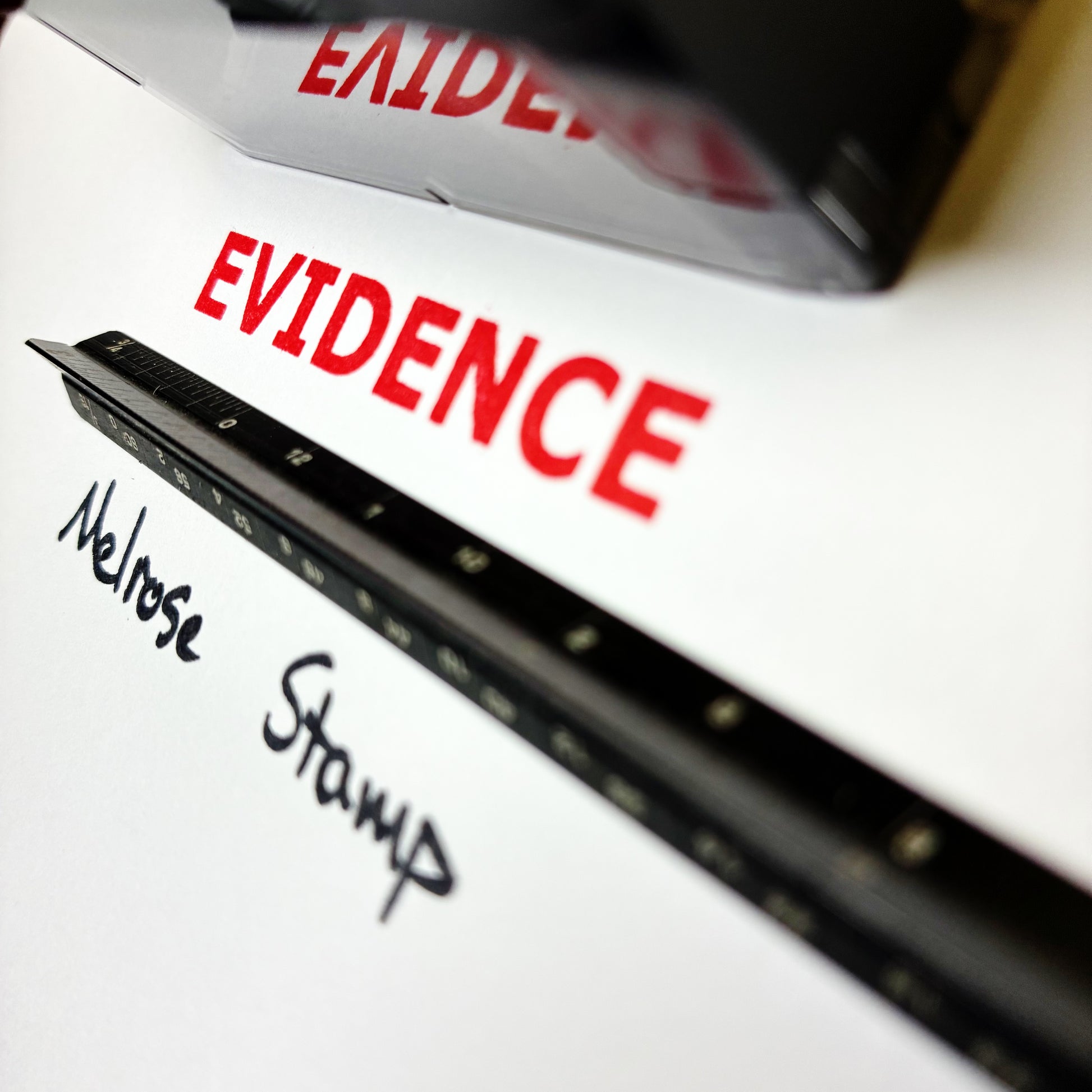 Document with 'EVIDENCE' printed in red and 'Melrose Stamp' written below, with a stamp in the background.