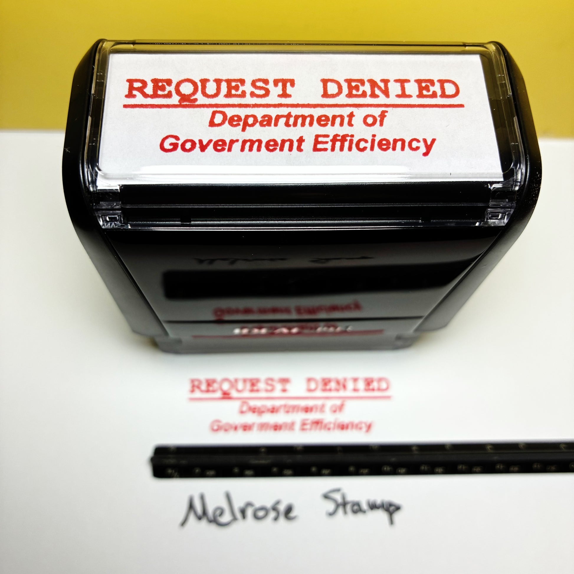 Rubber stamp with 'REQUEST DENIED Department of Government Efficiency' DOGE
