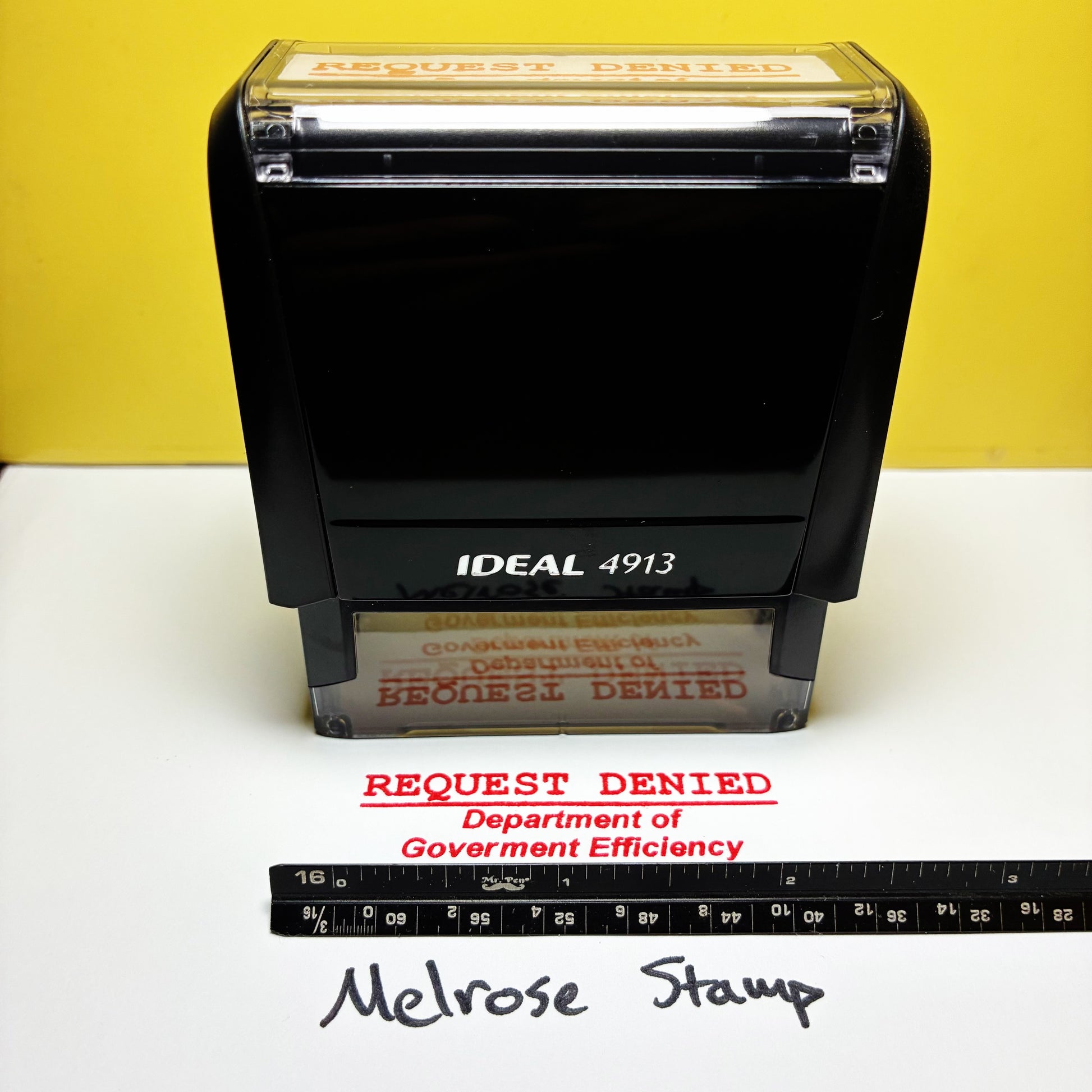 Black stamp with 'Request Denied' text on a yellow background