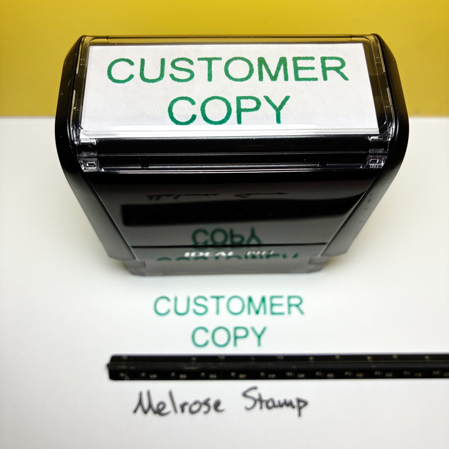 Self-inking stamp with 'CUSTOMER COPY' text on a white background