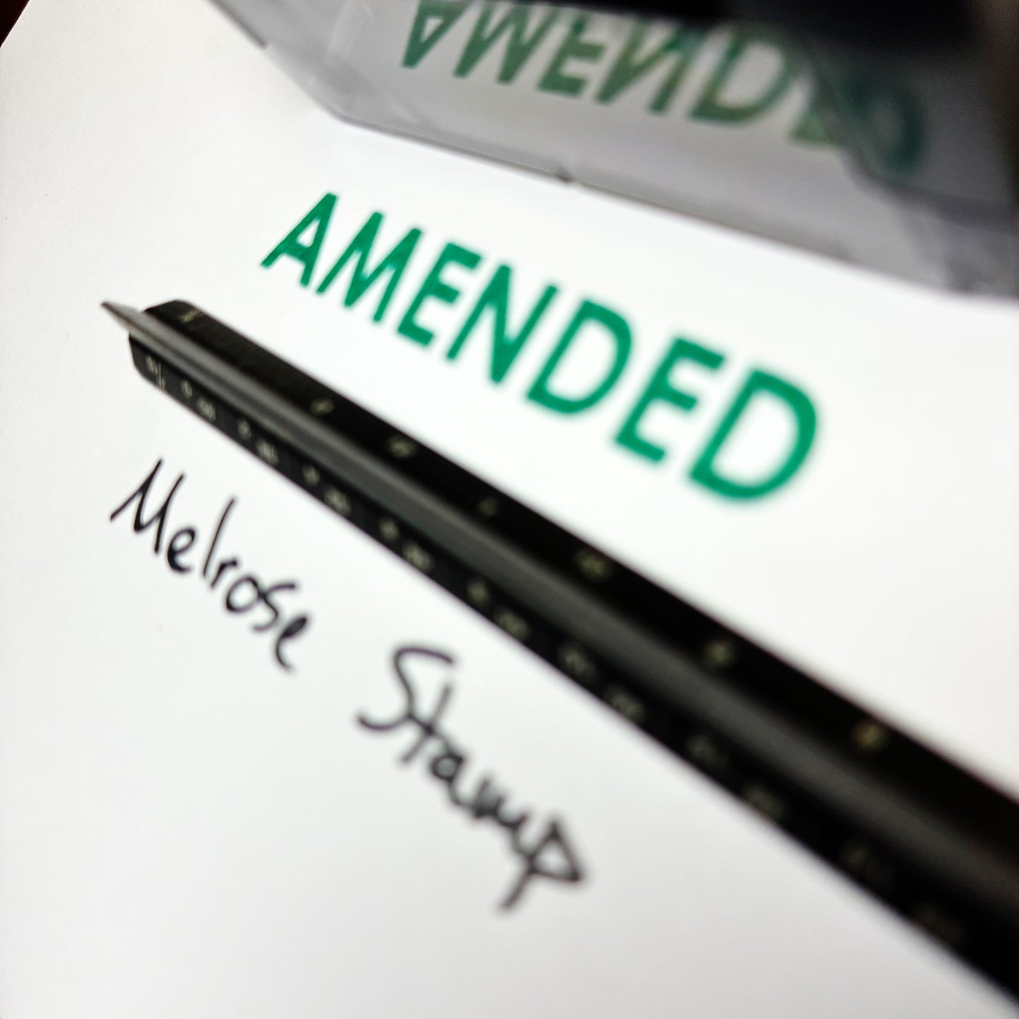 Document with 'AMENDED' in green ink and 'Melrose Stamp' signature.