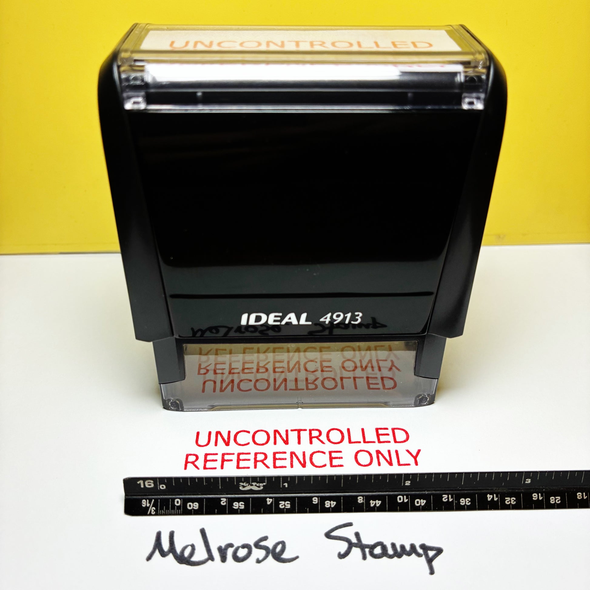 Rubber stamp with 'UNCONTROLLED REFERENCE ONLY' red ink on a white surface with a yellow background.