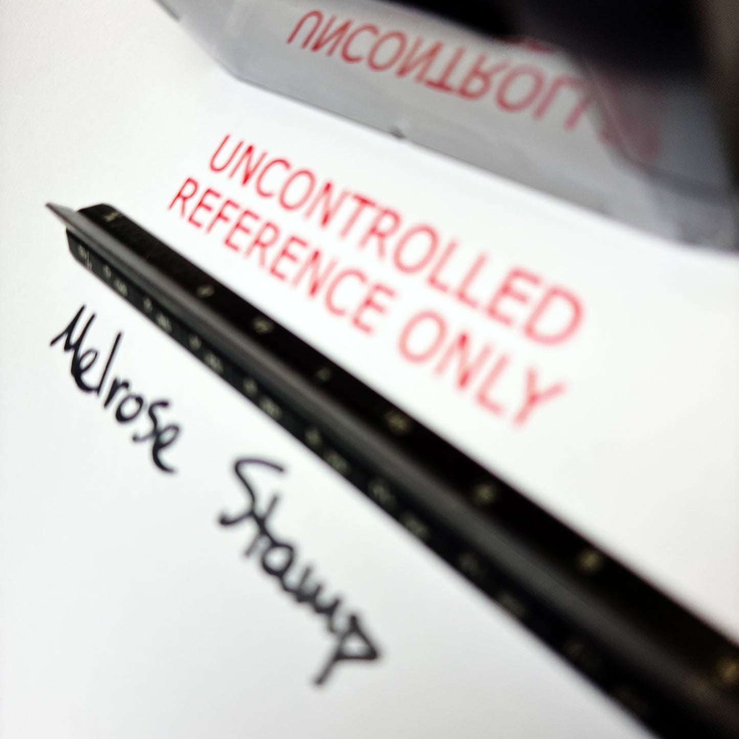 Close-up of a document with 'Uncontrolled Reference Only' rubber stamp red ink on a white background.