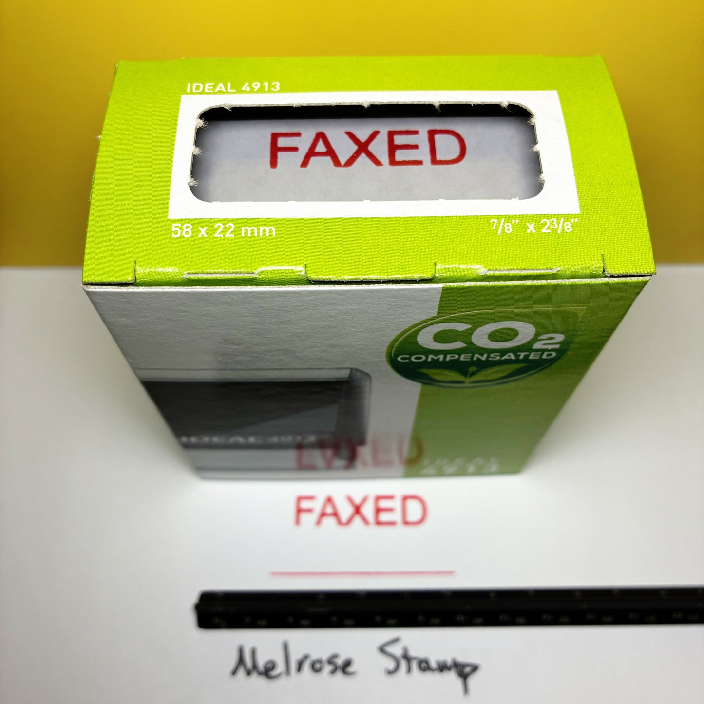 Green box with 'FAXED' rubber stamps red ink on a white surface