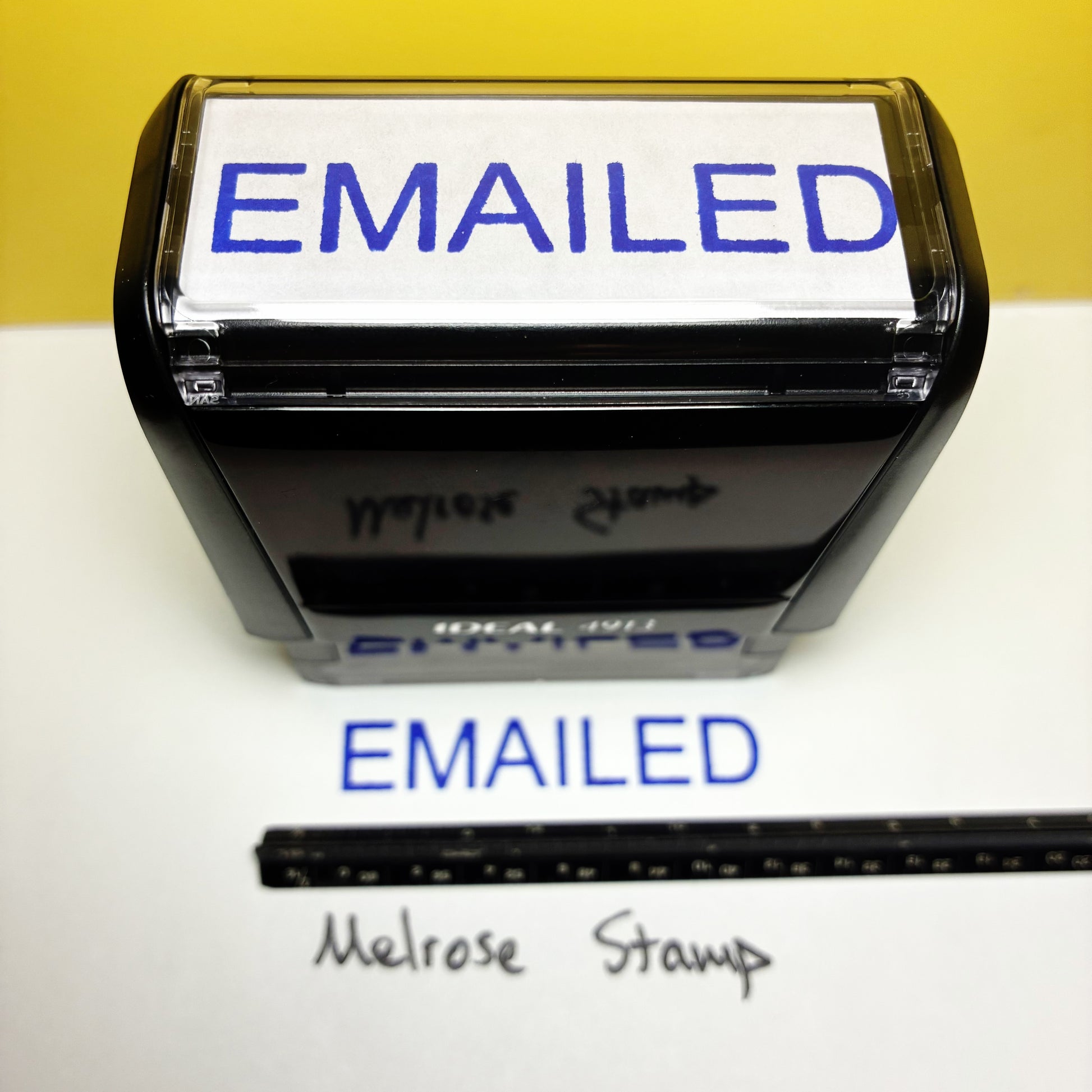 Self-inking stamp with 'EMAILED' text on a white background