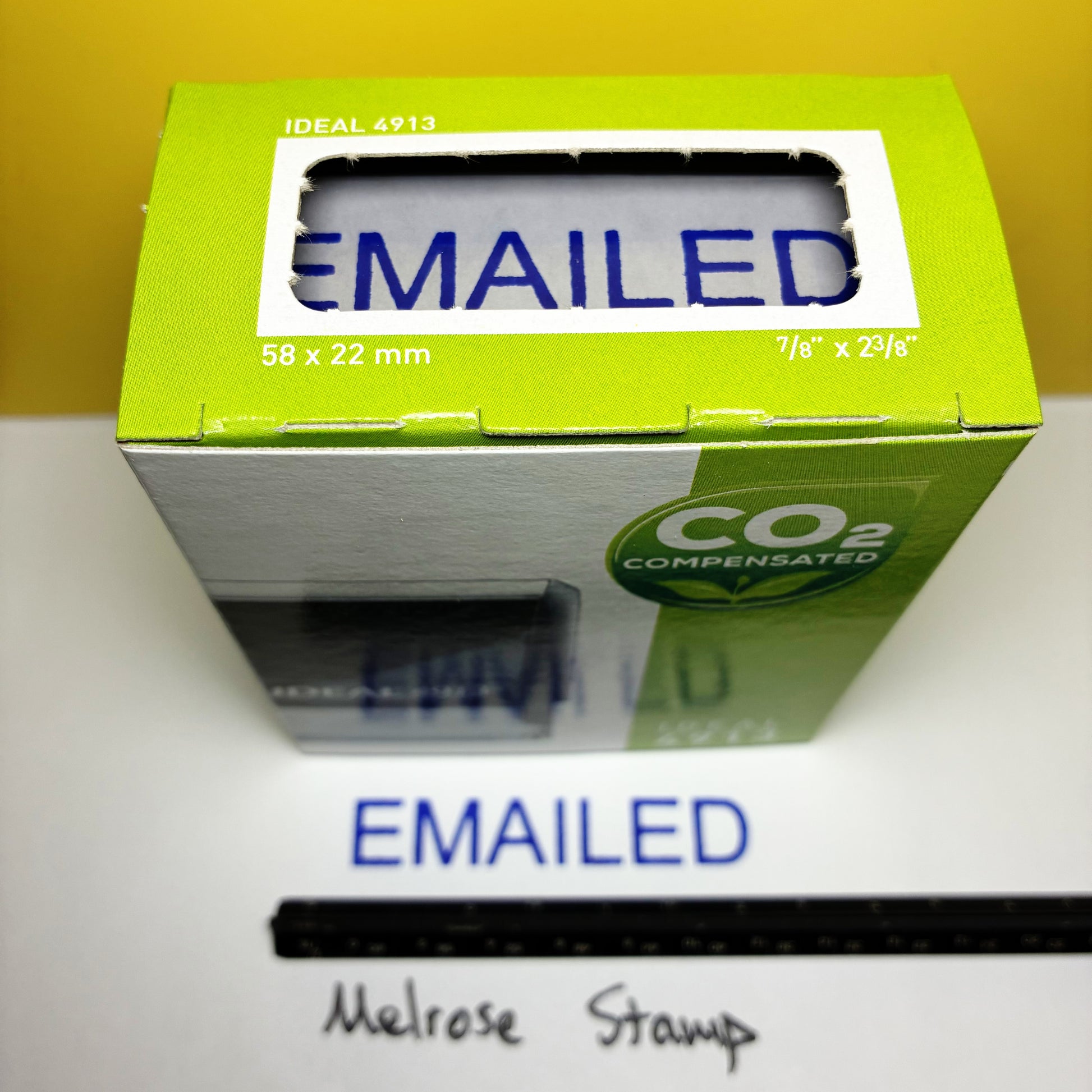 Green box 'EMAILED' rubber stamp blue ink on a white surface.