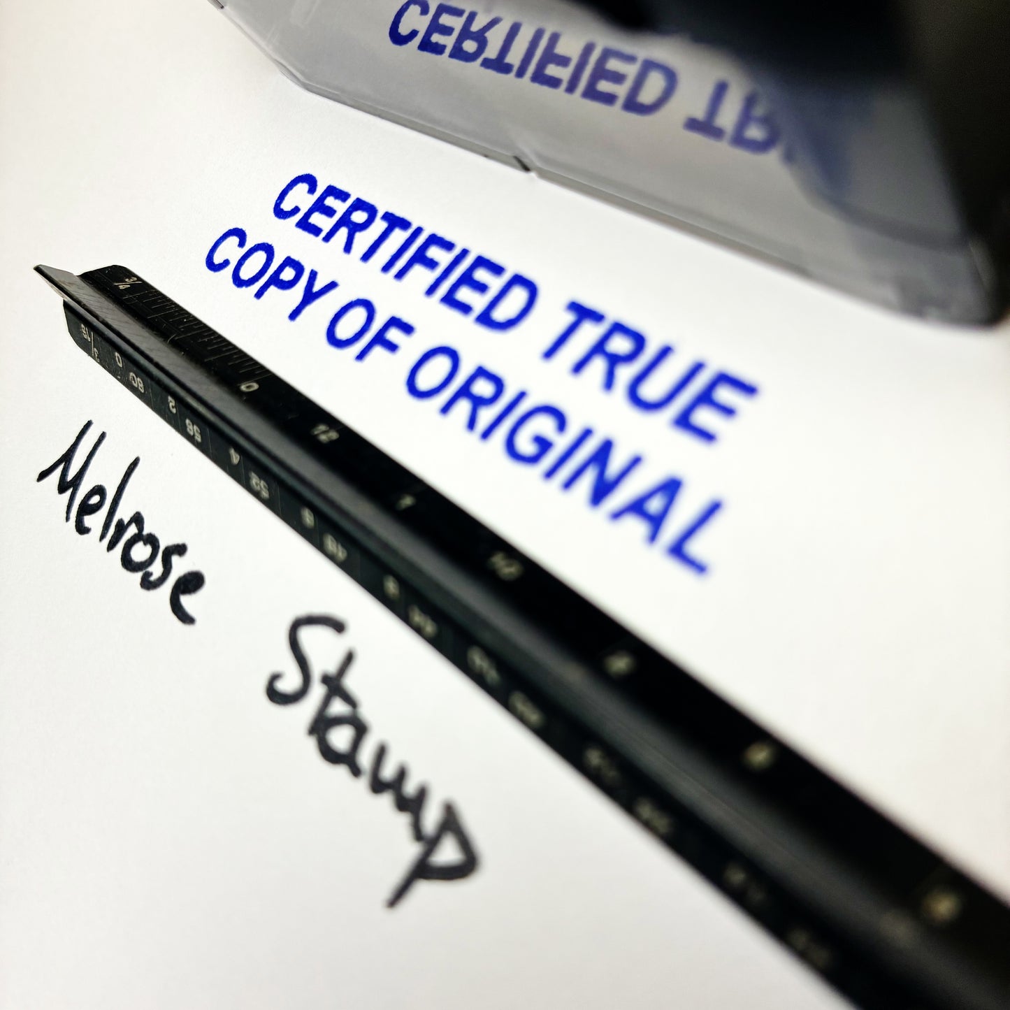 Close-up of a document with 'Certified True Copy of Original' text and a stamp