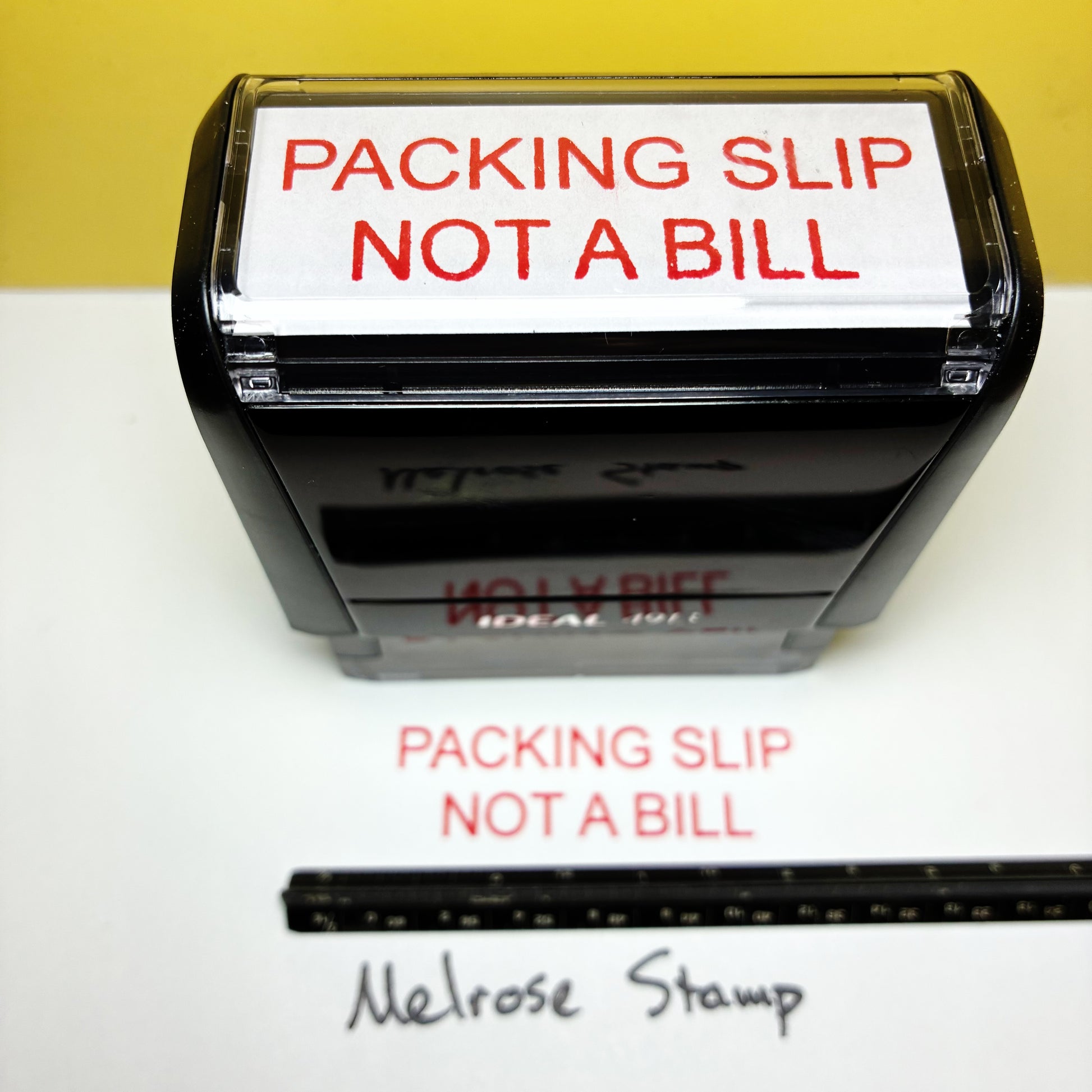 Rubber stamp with 'Packing Slip Not a Bill' text on a white background