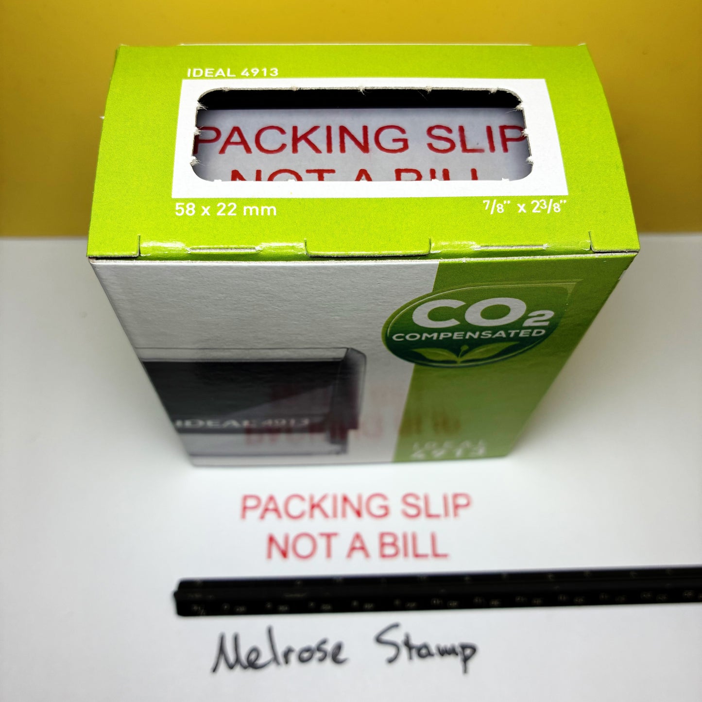 Green box 'Packing Slip Not a Bill' text rubber stamp on a white surface.