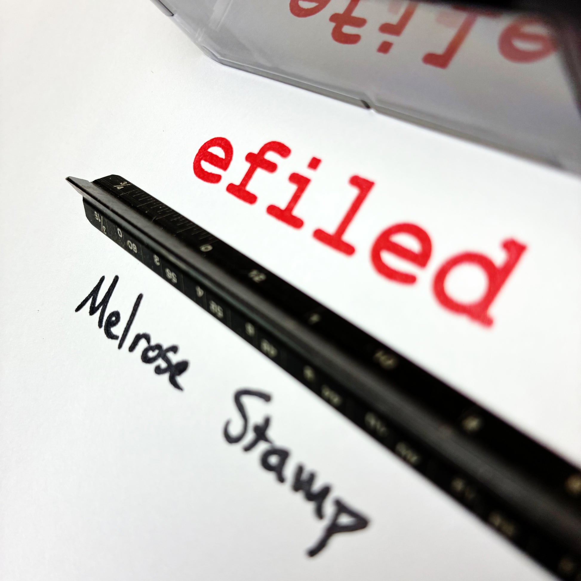 Rubber stamp with 'efiled' and 'Melrose Stamp' text on a white background