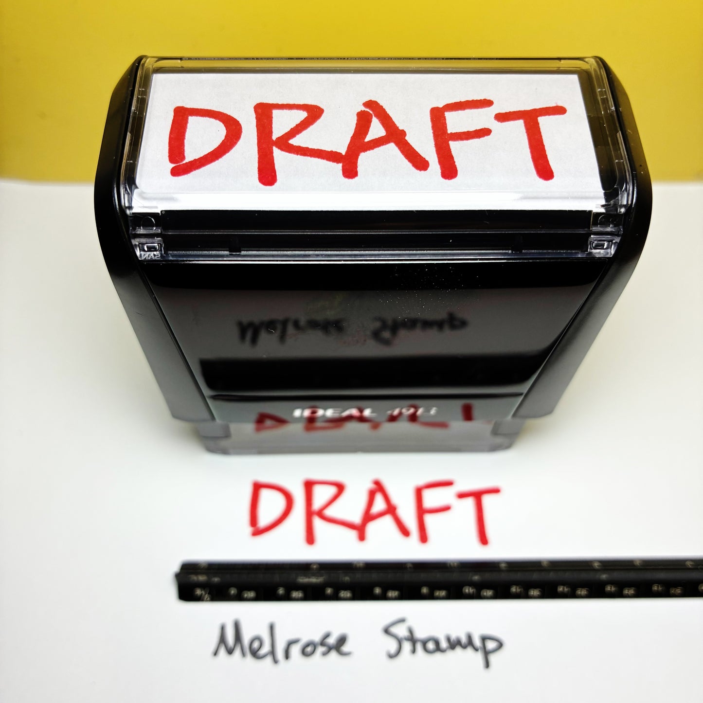 Rubber stamp with 'DRAFT' text on a white background