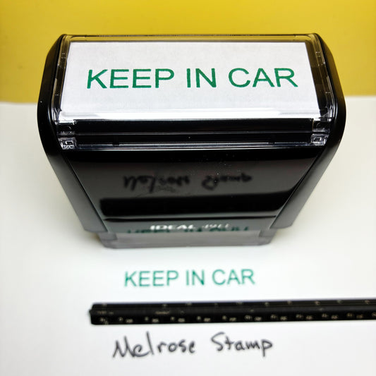 Stamp with 'KEEP IN CAR' text and a ruler for size reference on a white background.