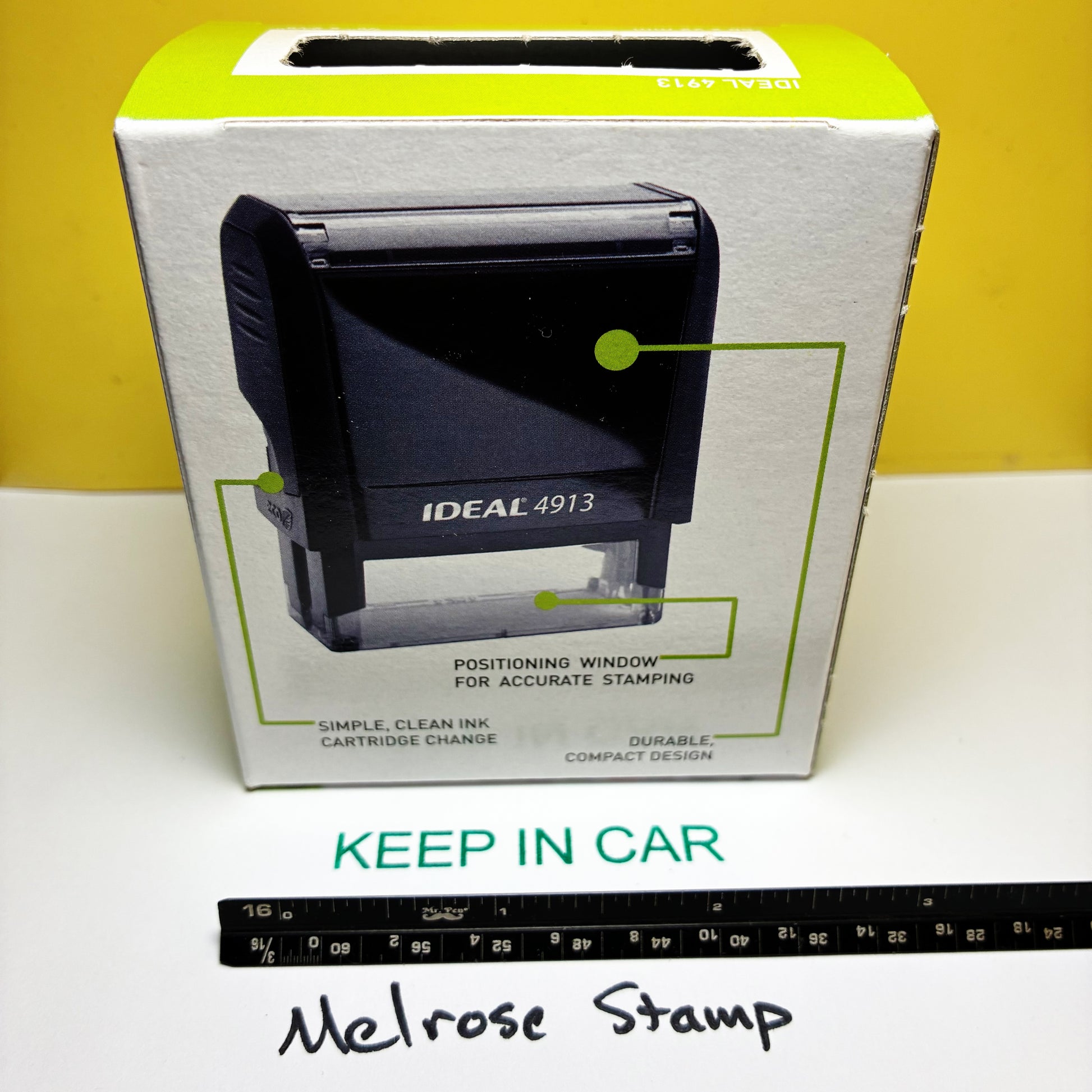 Rubber stamp Keep In Car with a ruler at the bottom