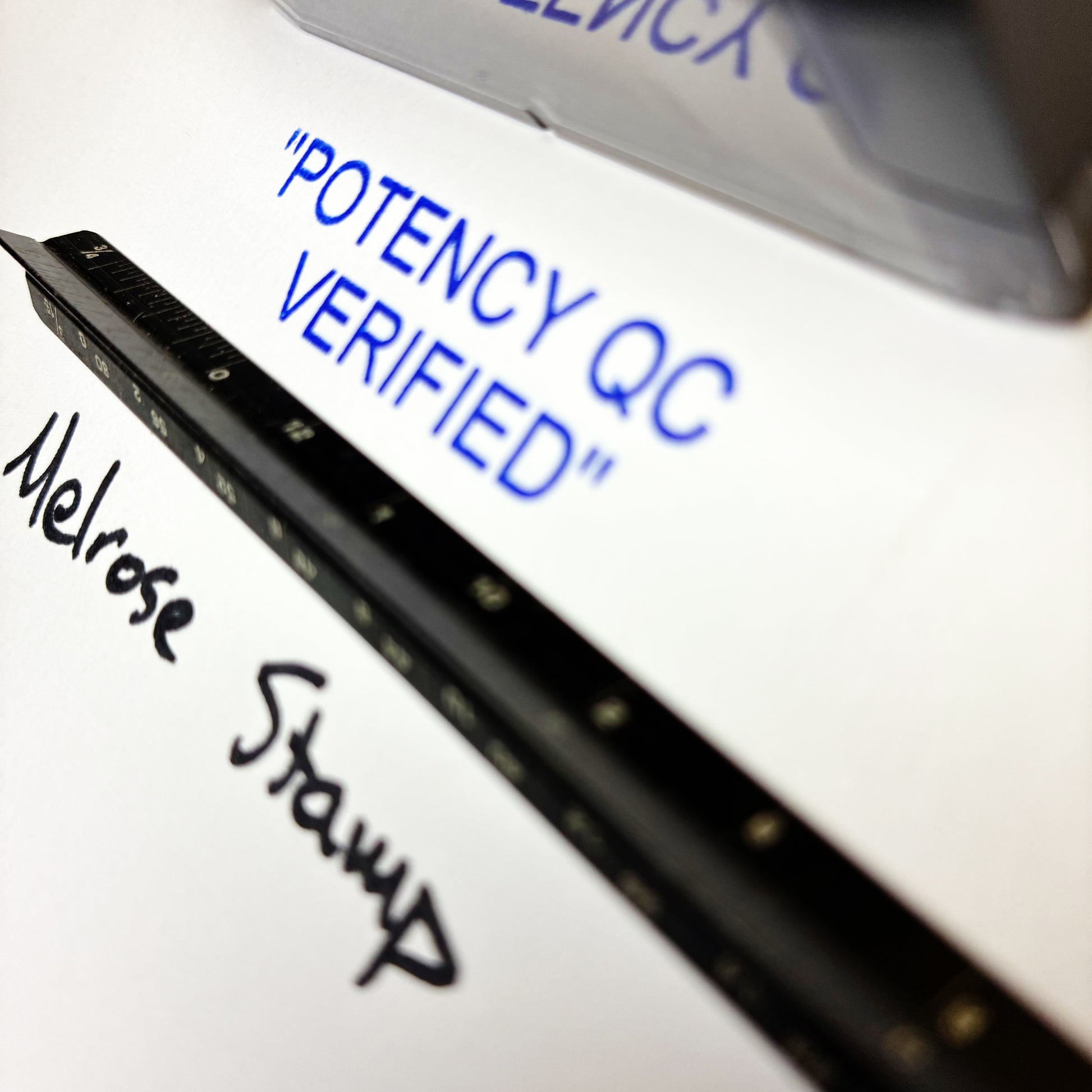 POTENCY QC VERIFIED stamp close up on paper