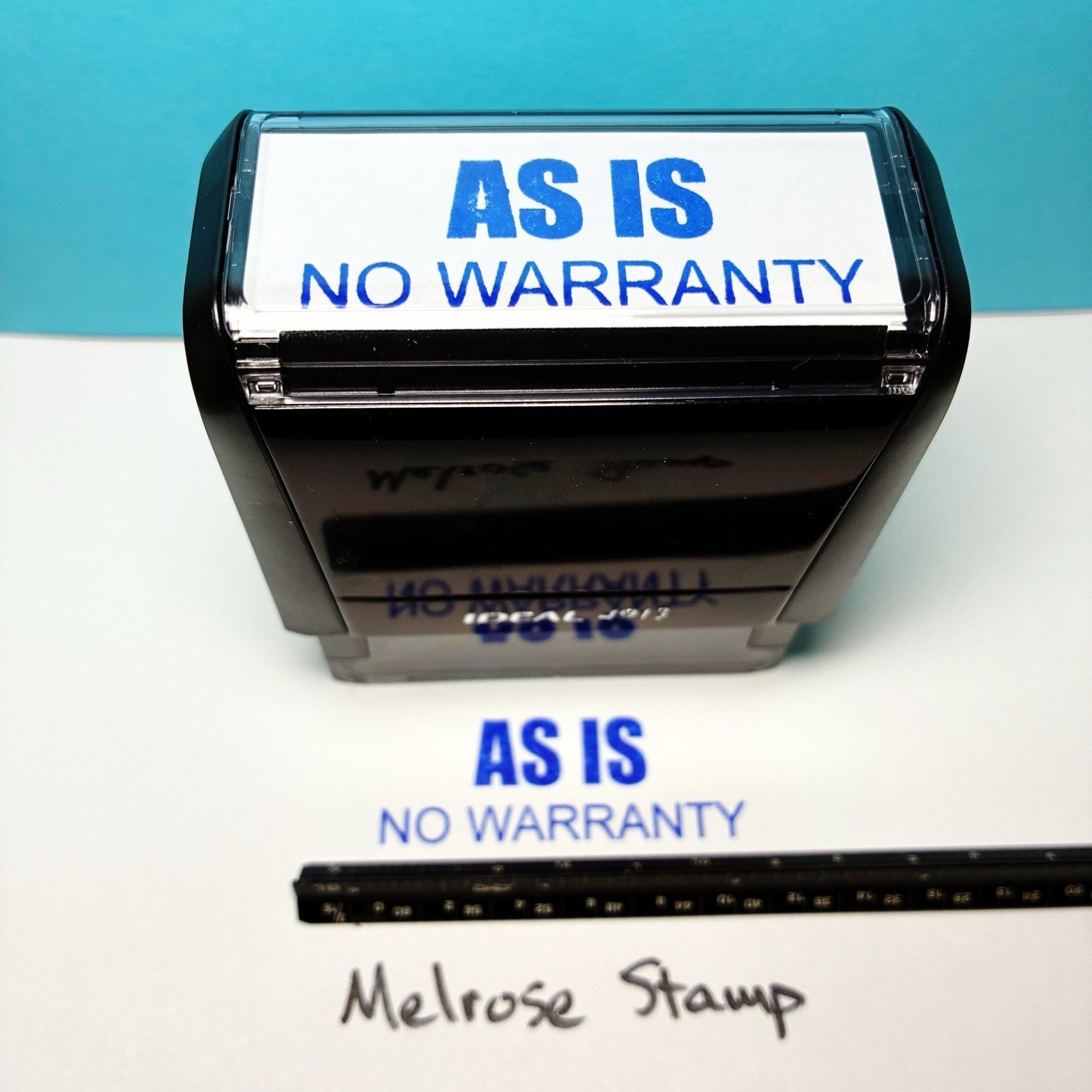 Stamp with 'AS IS NO WARRANTY' text on a white surface with blue background
