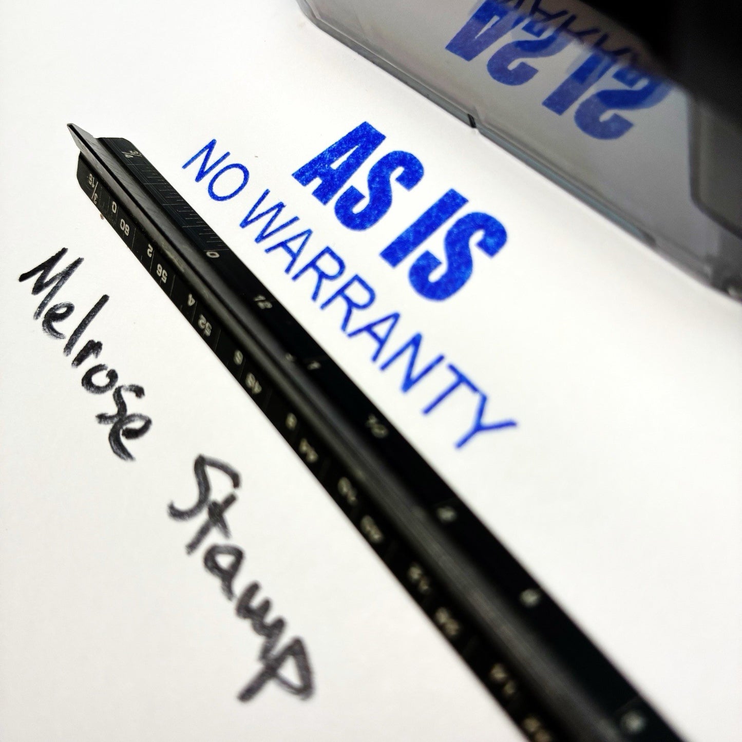 Black stamp with 'AS IS NO WARRANTY' text on a white background