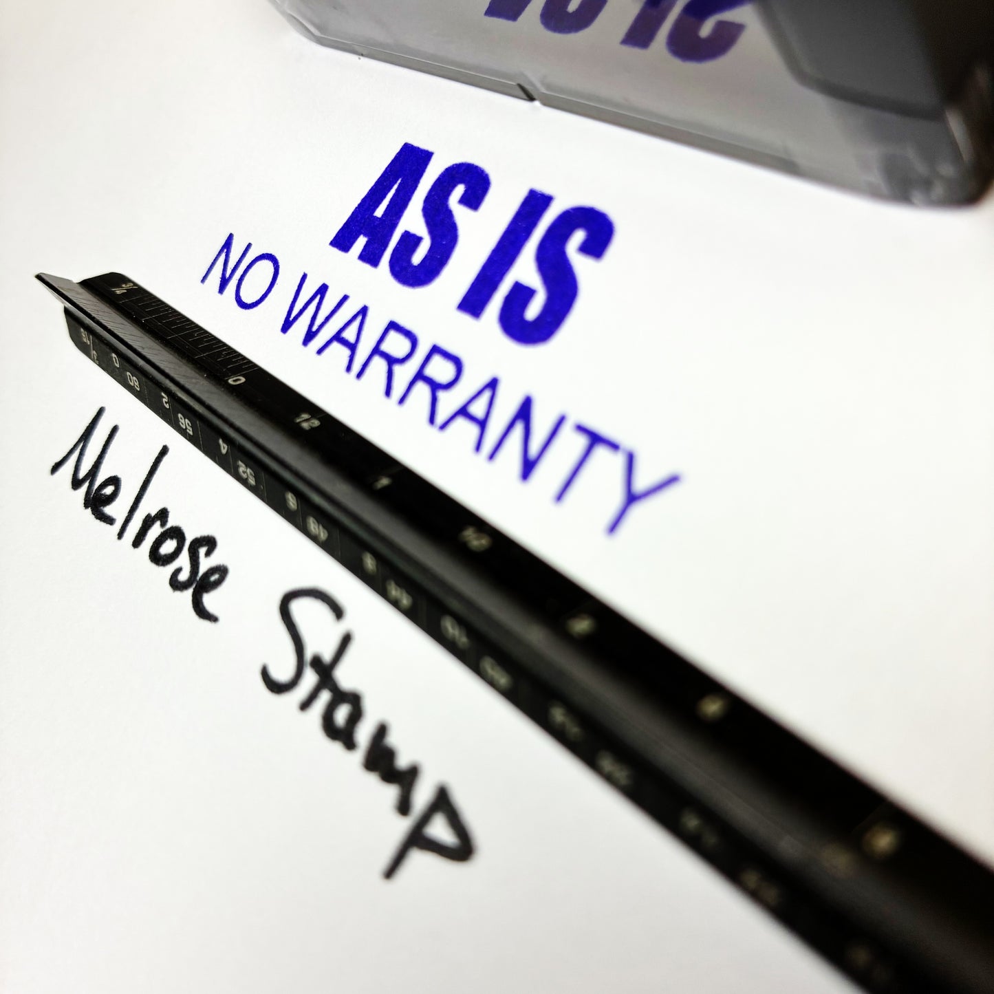 Black stamp with 'AS IS NO WARRANTY' text on a white background