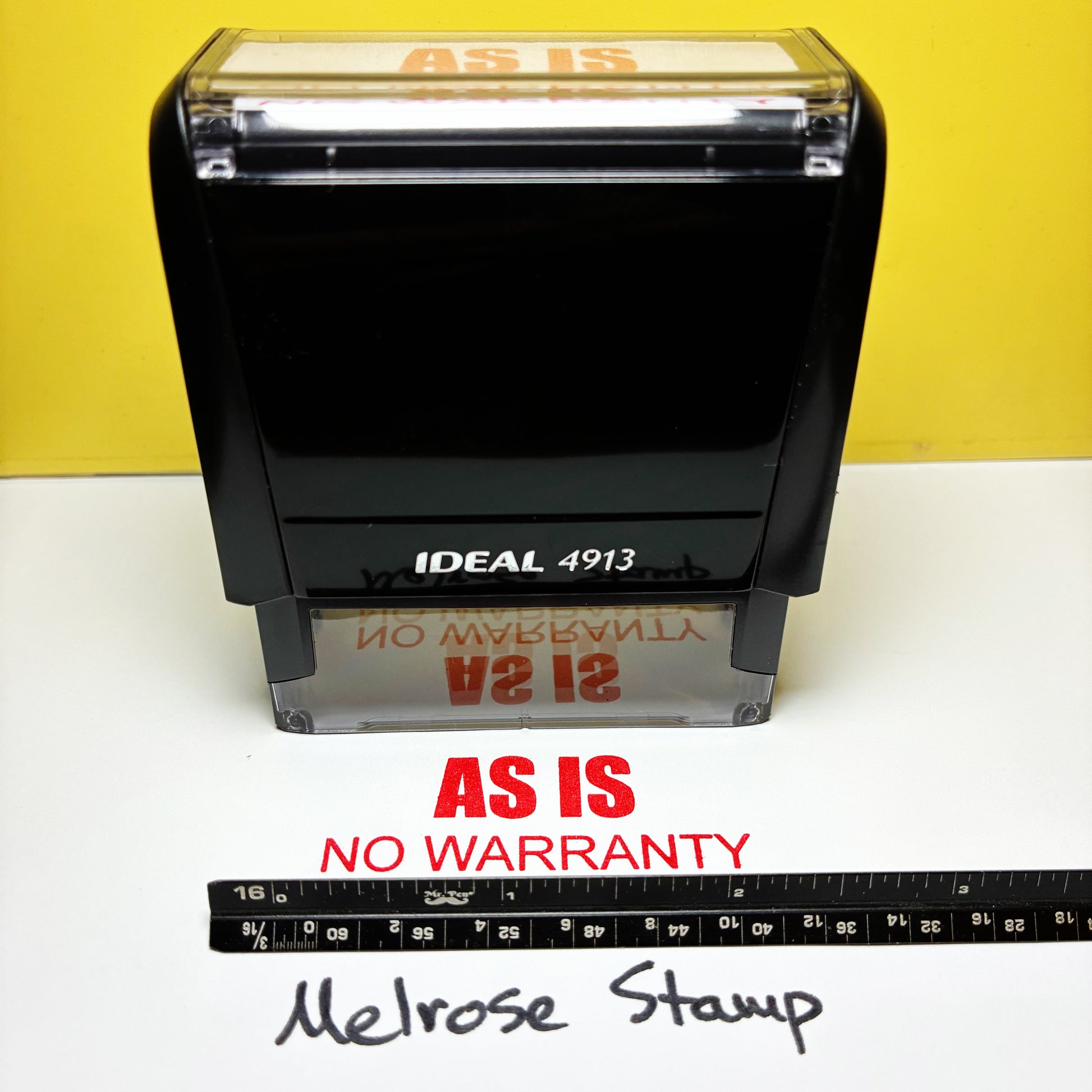 Rubber stamp with 'AS IS NO WARRANTY' red ink on a yellow and white background