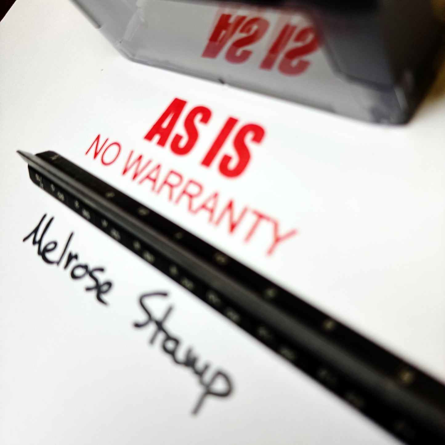 Rubber stamp with 'AS IS NO WARRANTY'  red ink self-inking
