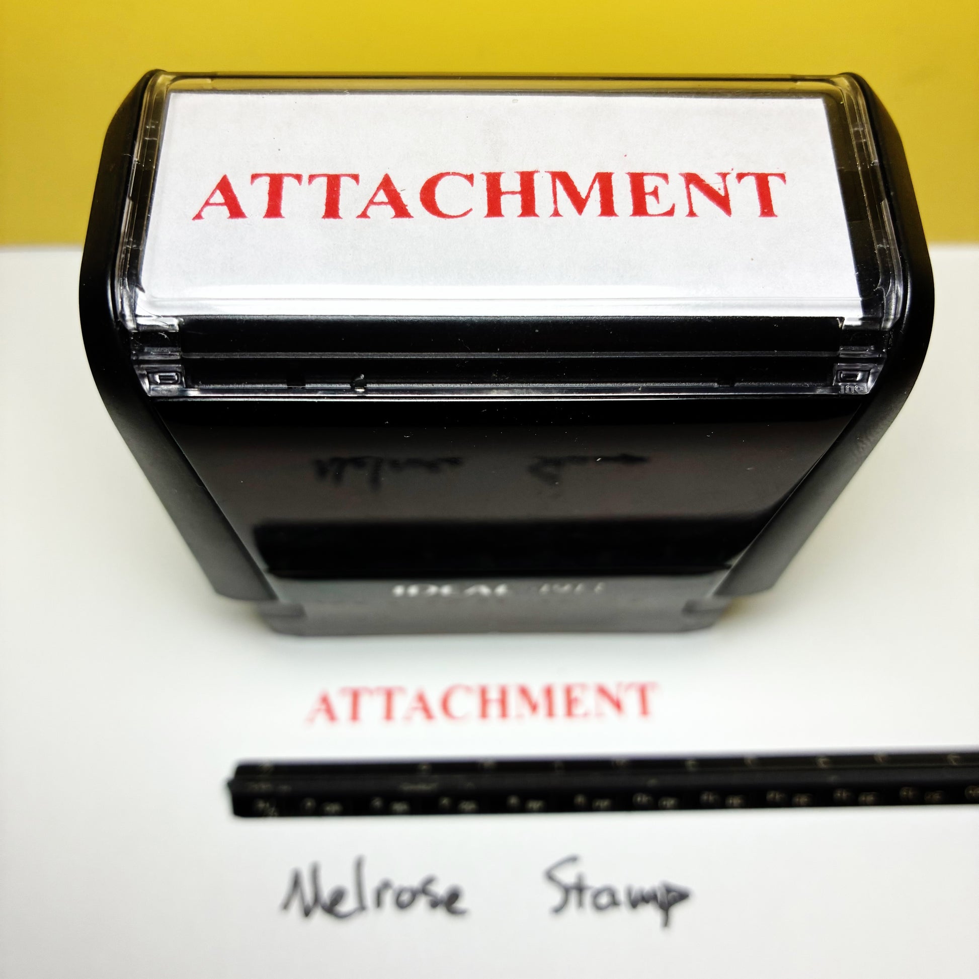 Rubber stamp with 'ATTACHMENT' text on a white background