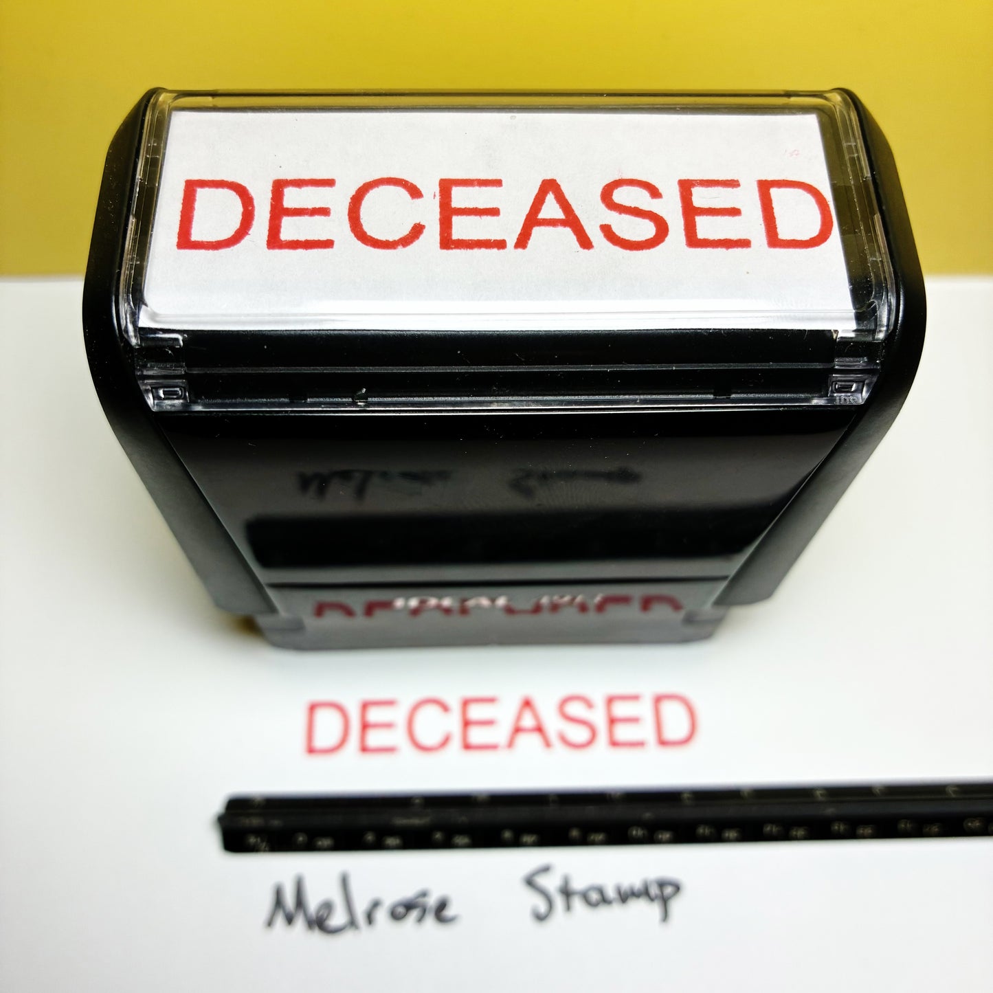 Stamp with 'DECEASED' text on a white background
